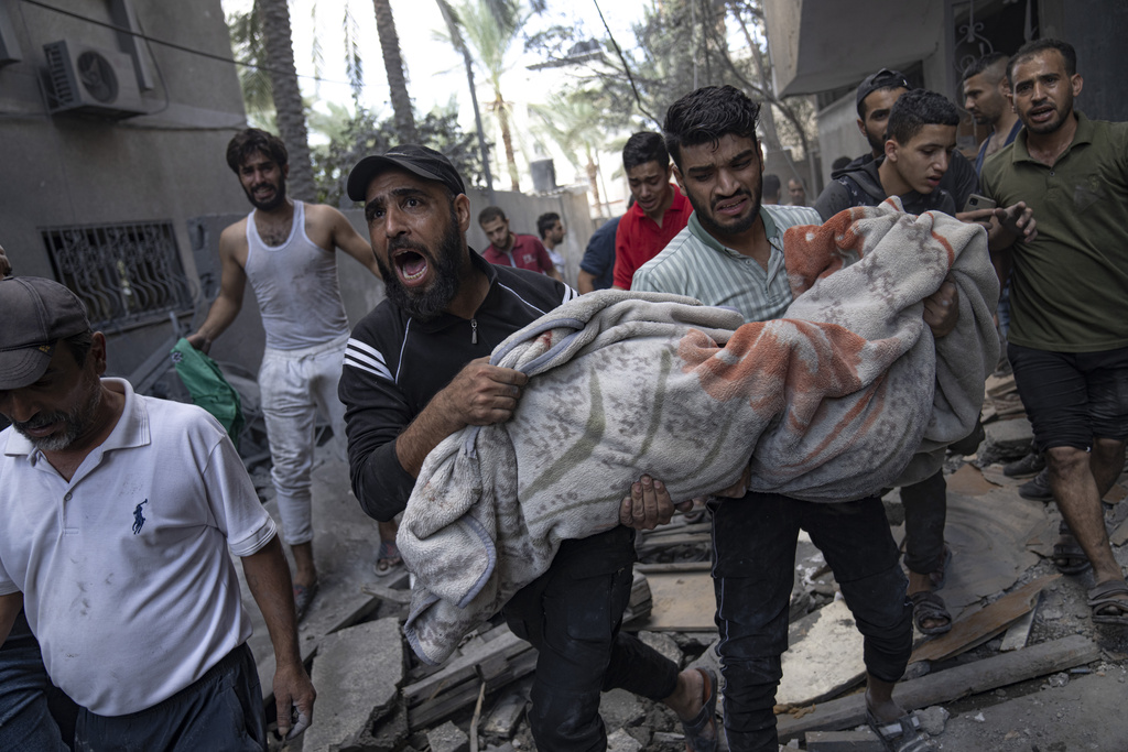 Palestinians evacuate wounded from a building destroyed in Israeli bombardment in Rafah refugee camp in Gaza Strip on October 17. Photo / AP
