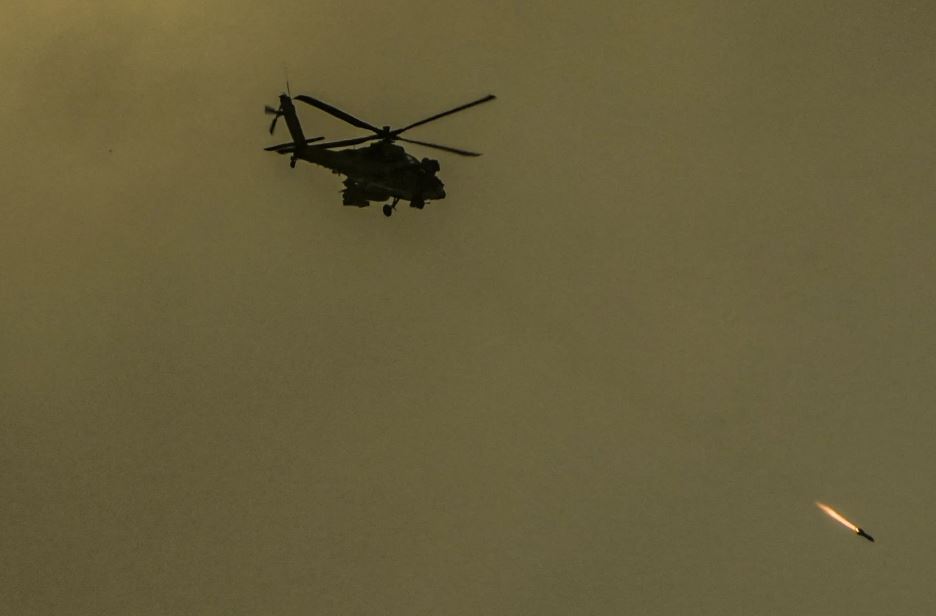 An Israeli Apache helicopter fires a missile in the direction of the Gaza Strip, as seen from southern Israel. Photo / AP