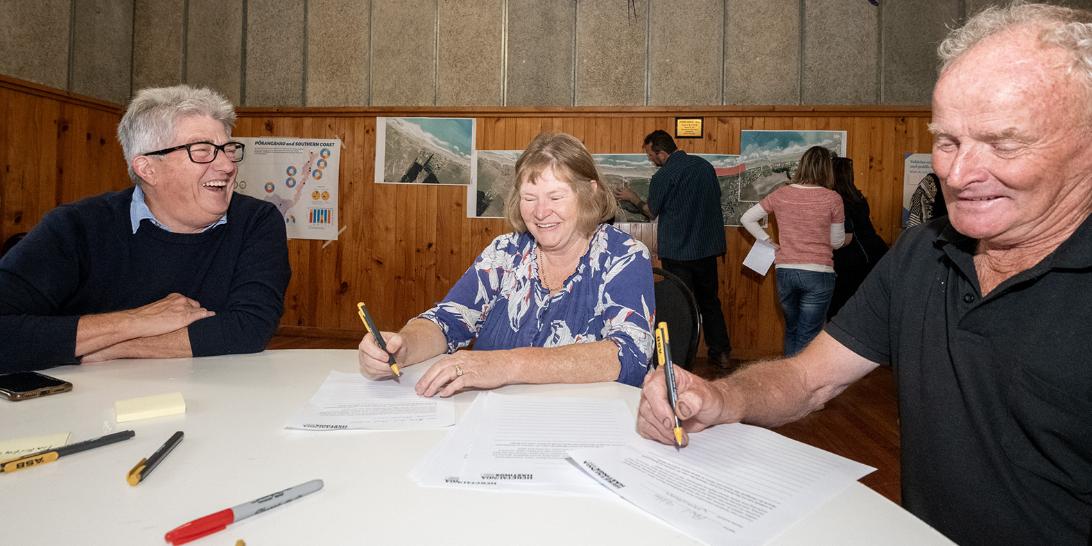 Colin Hosford, left, from HDC talks to Waimarama locals Anne and Paul Gibbs. Photo / Connull Lang
