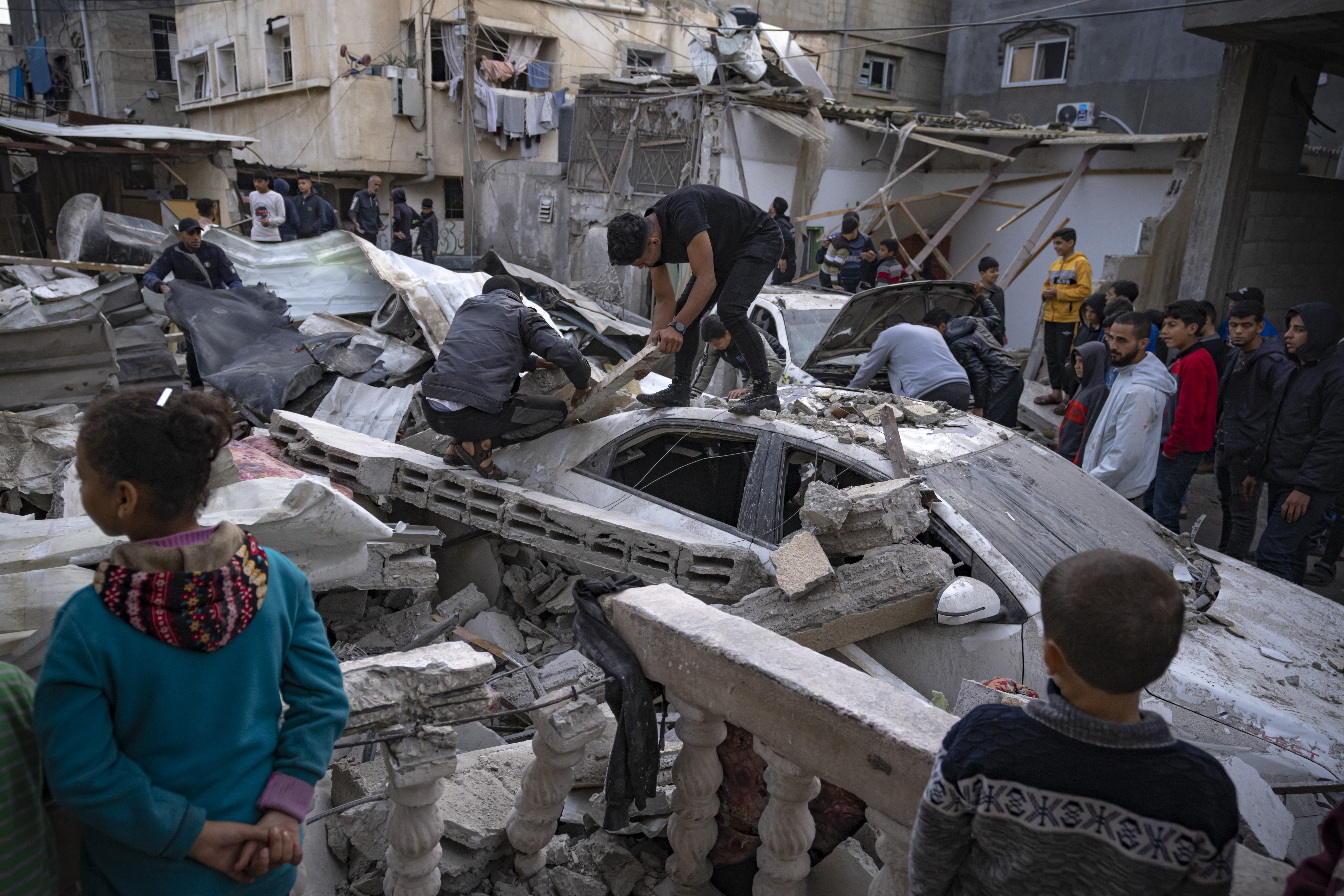 Palestinians inspect a house after it was hit by an Israeli bombardment on Rafah, southern Gaza Strip. Photo / AP