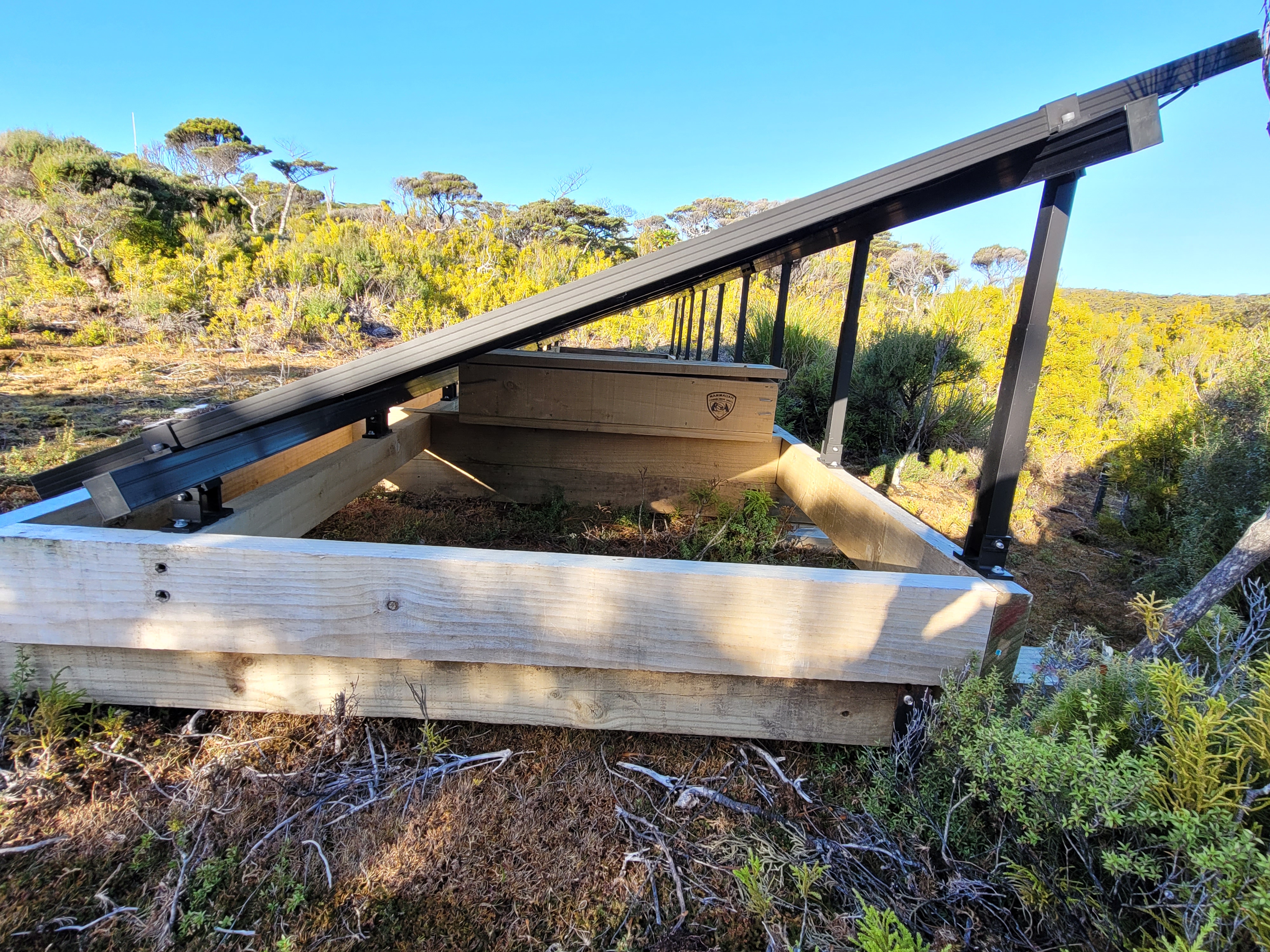 The trap set under solar panels next to the Department of Conservation hut on Chalky Island is where the stoat was eventually found dead. Photo / DoC