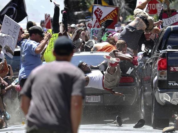People fly into the air as a vehicle drives into a group of protesters demonstrating against a white nationalist rally in Charlottesville, Virginia. Photo: Ryan M. Kelly/The Daily Progress via AP