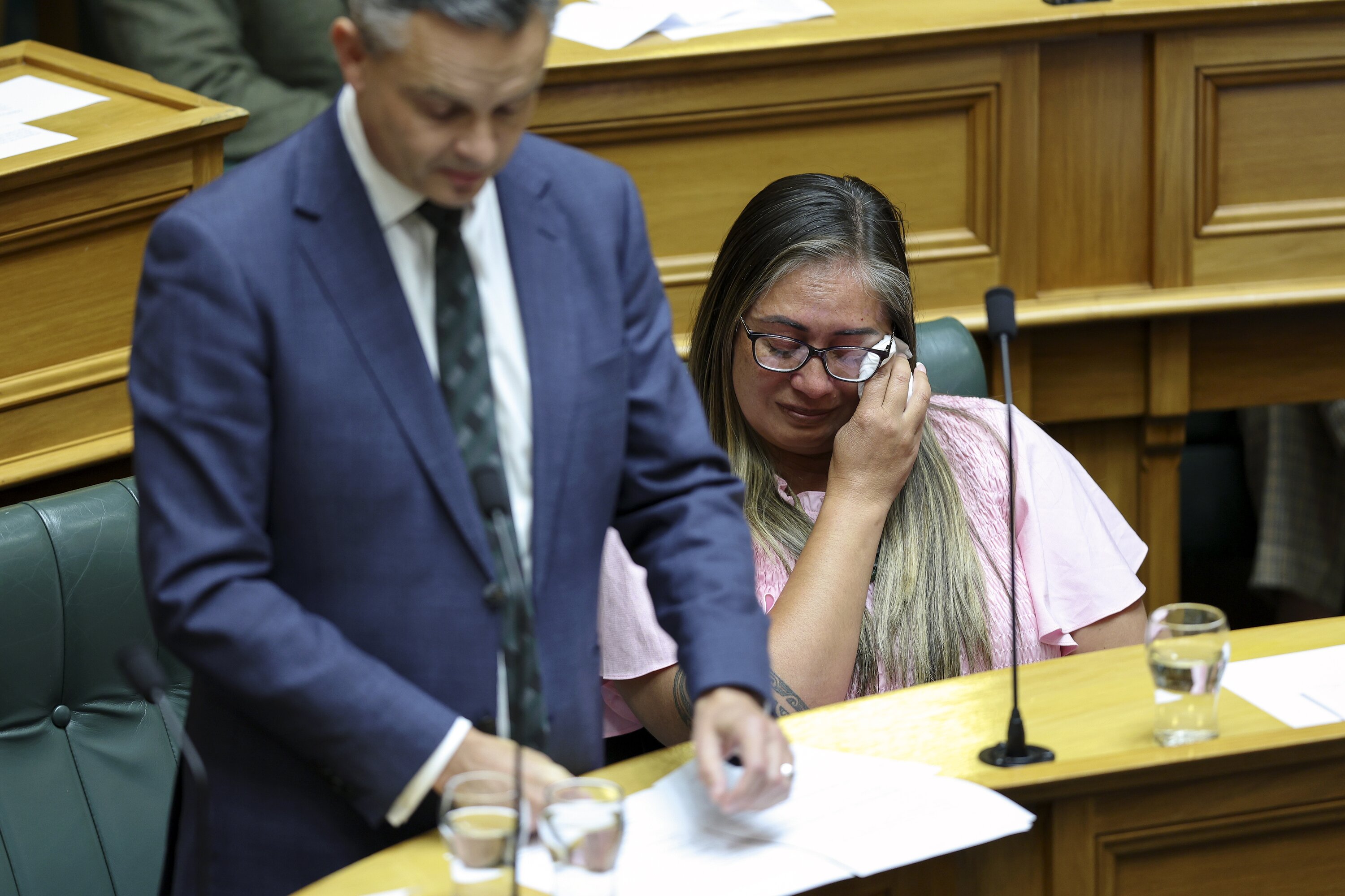 Green MP Huhana Lyndon cries during a tribute to Efeso Collins at Parliament in Wellington on Wednesday 21 Feb 2024. Green MP Efeso Collins collapsed and died while taking part in the ChildFund Water Run in Auckland. Credit: Hagen Hopkins.