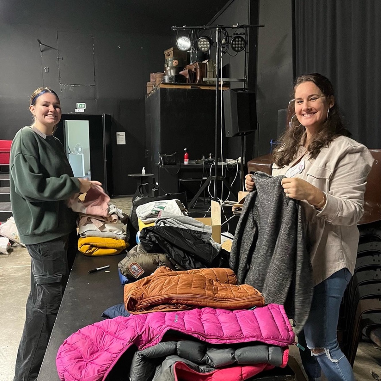 Bald Angels volunteers Keshama Jane and Chelsea Charlton help sort and pack winter coats donated to the charity’s “Keep Our Kids Warm” campaign.