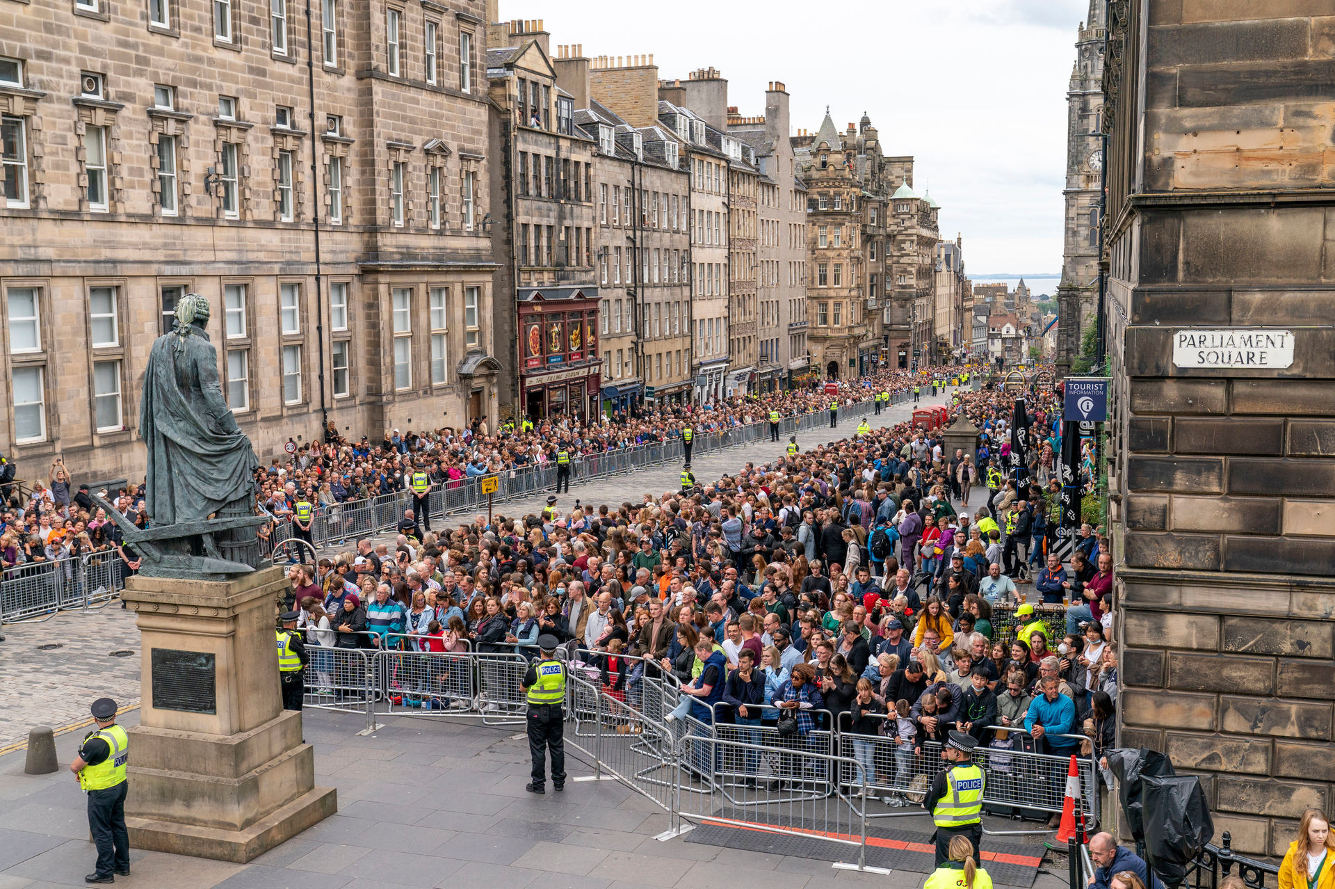 Crowds line the Royal Mile in Edinburgh waiting for the hearse carrying the coffin of Queen Elizabeth II. Photo / Jane Barlow via AP