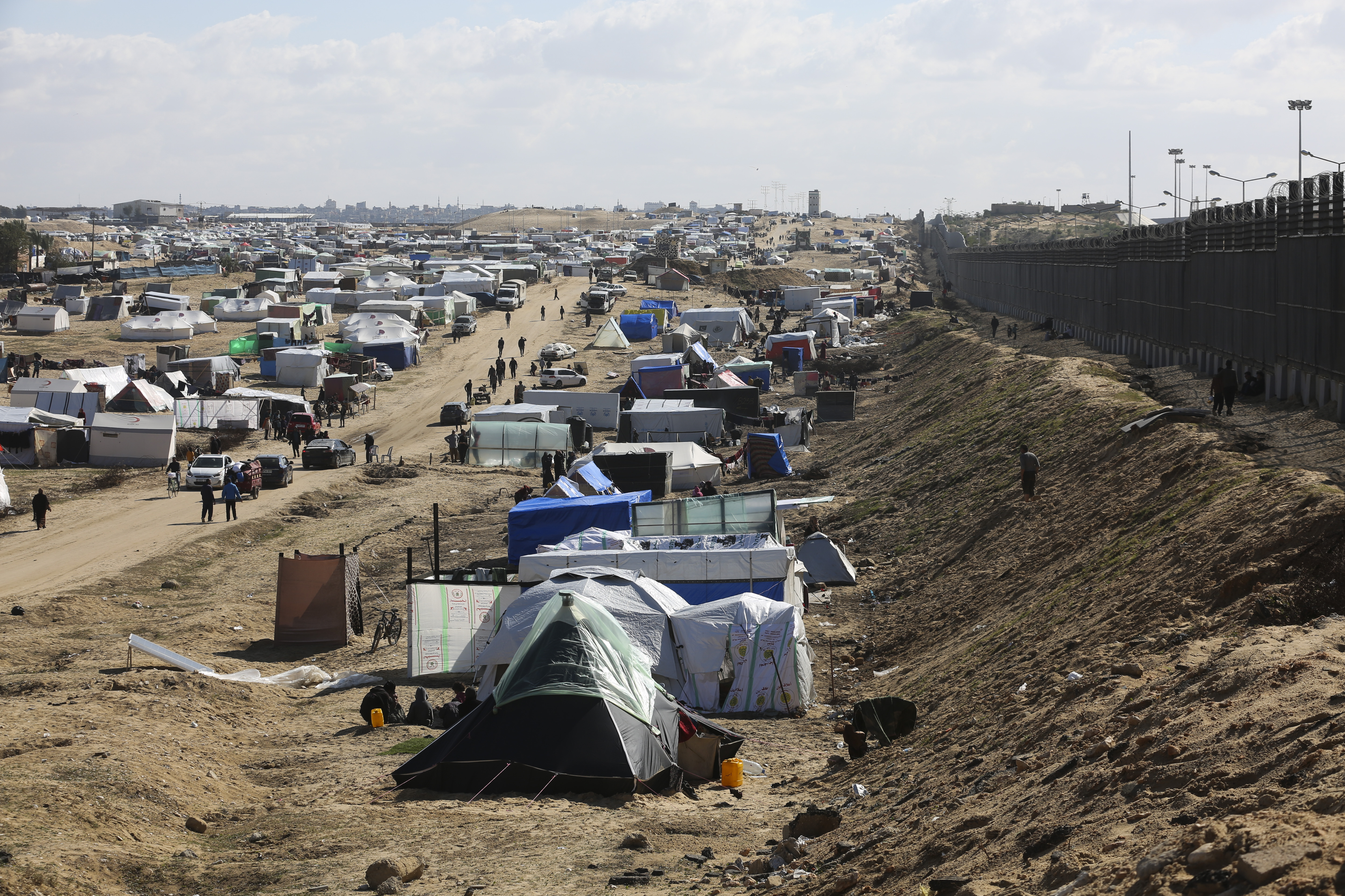 Palestinians displaced by the Israel air and ground offensive on the Gaza Striptake shelter near the border fence with Egypt in Rafah. Photo / AP