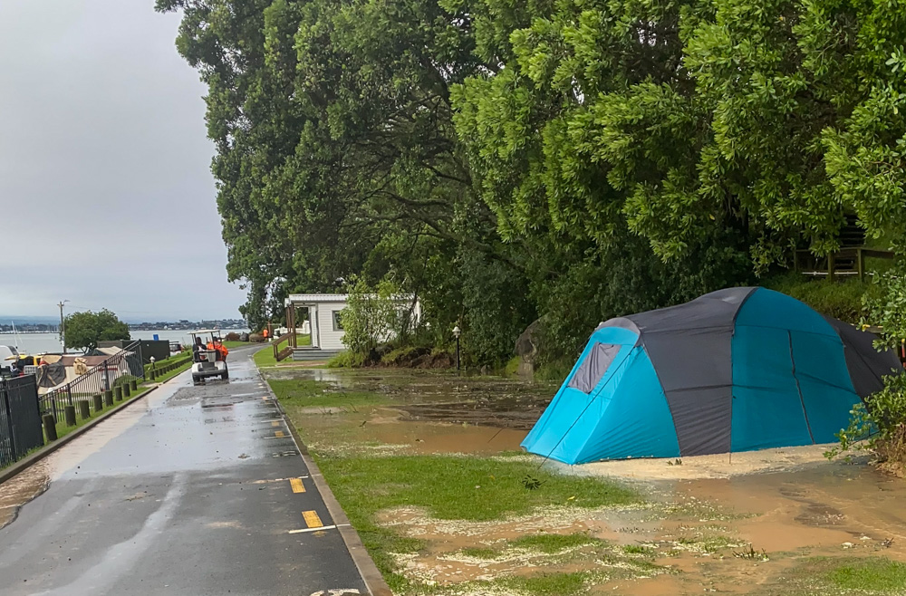 A photo at the Mount Maunganui campsite taken early Thursday show Lance Macfarlane's waterlogged tent and staff in a golf buggy at 7.42am. Photo / Colin McGonagle