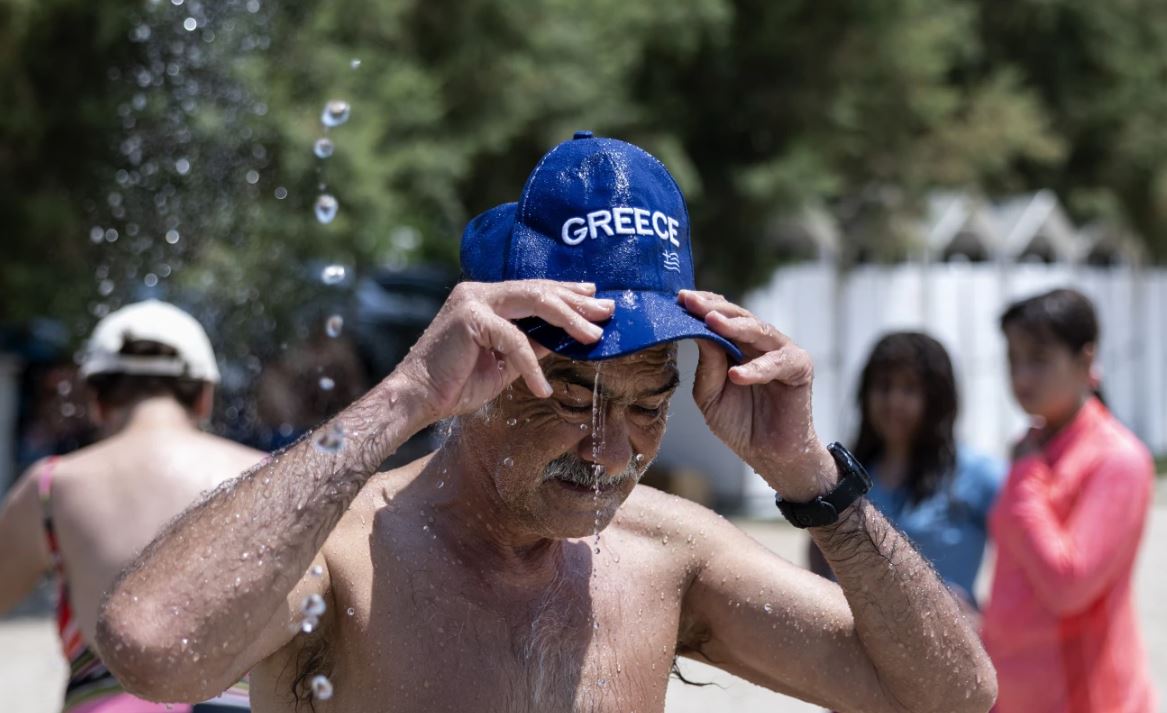 A swimmer cools himself in Athens. Photo / AP