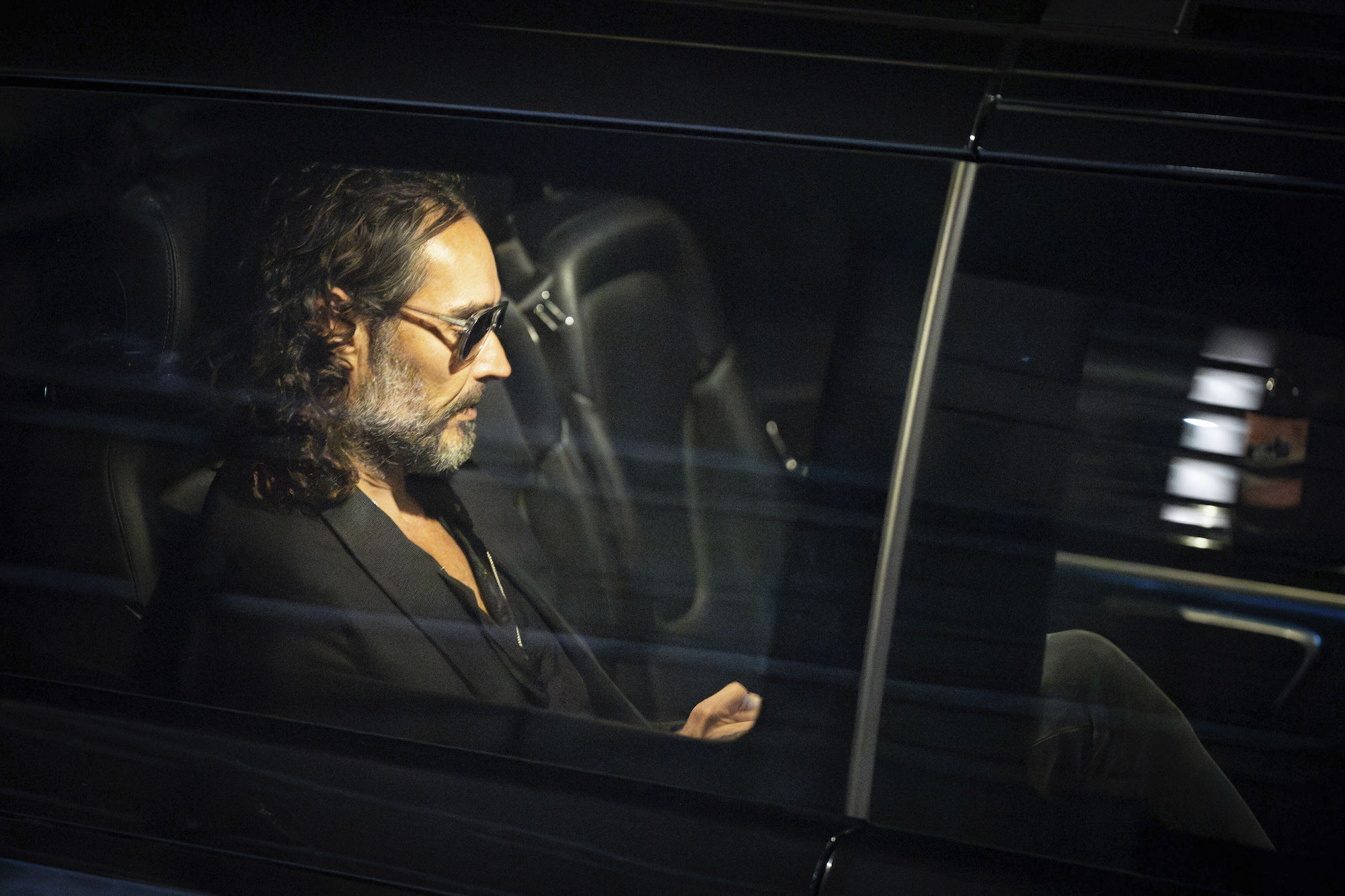 Russell Brand leaves the Troubabour Wembley Park theatre in northwest London after performing a comedy set last week. Photo / AP