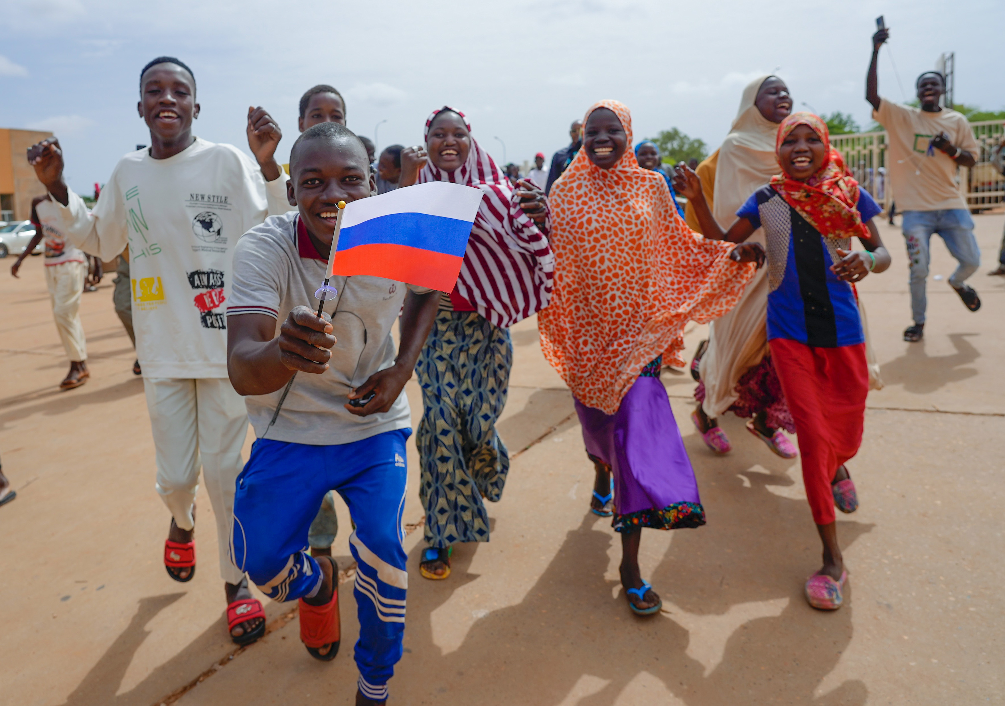 Supporters of Niger's ruling junta hold a Russian flag in Niamey on Sunday. Photo / AP