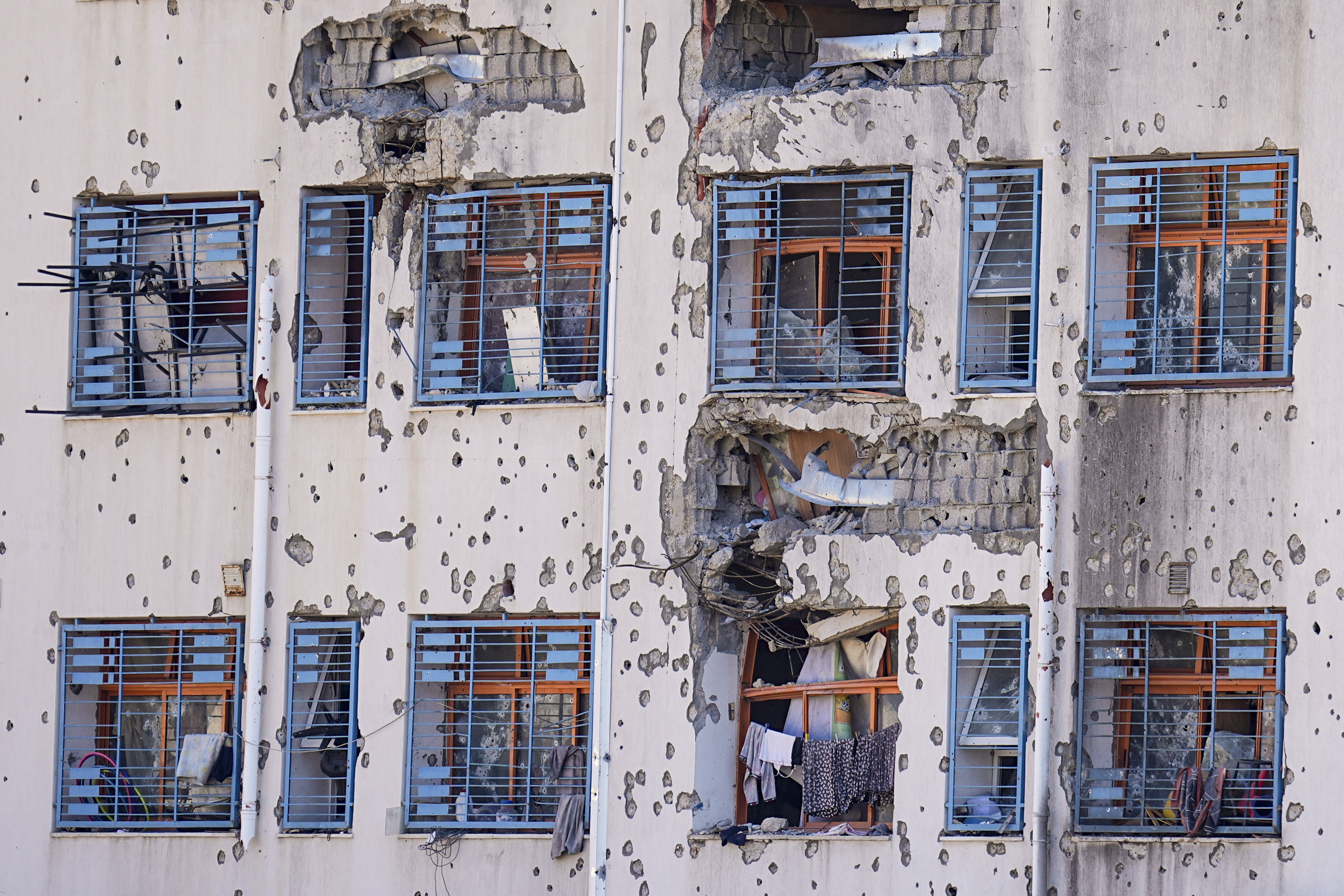 Bullet holes and shrapnel pockmark the walls of buildings in Gaza. Photo / AP