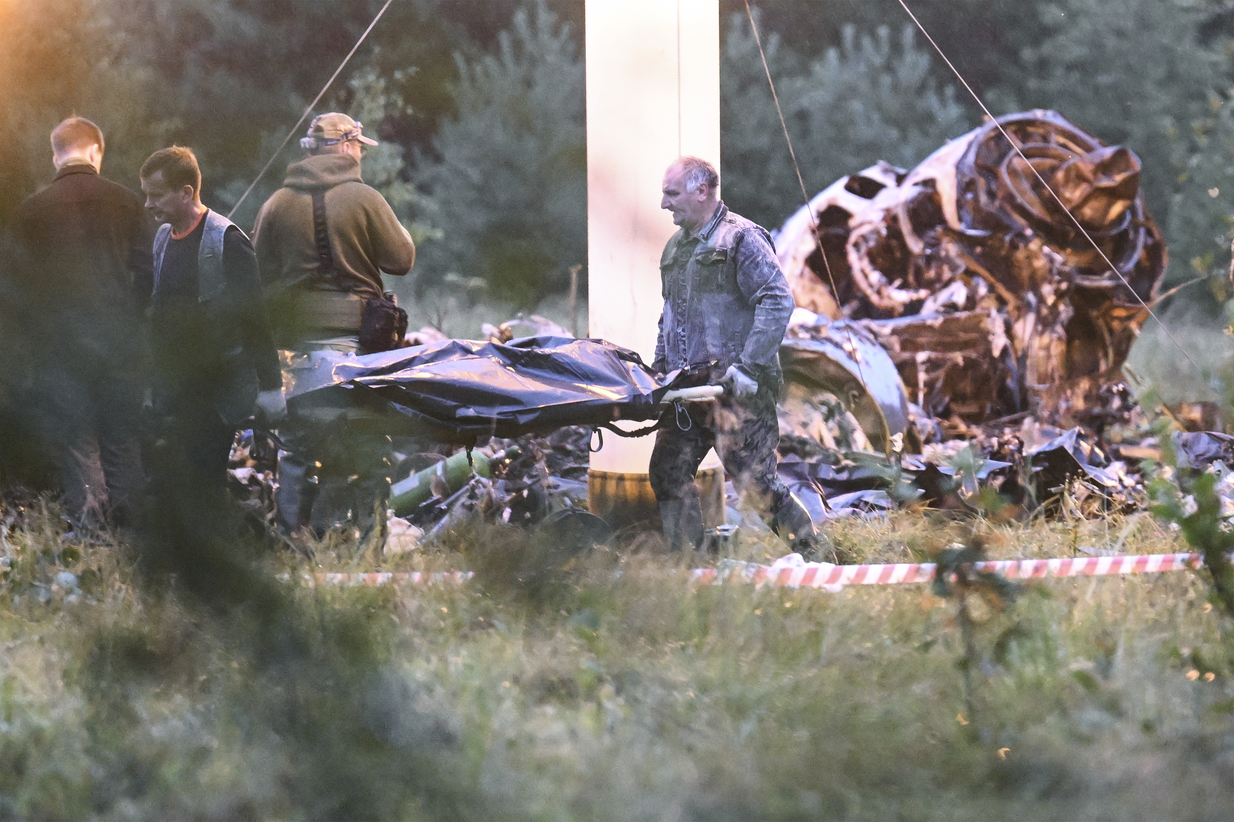 Workers clear the wreckage of a crashed private jet, near the village of Kuzhenkino. Photo / AP