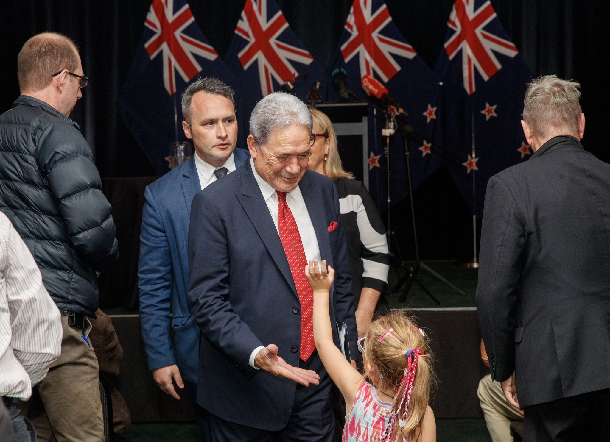 Alexia Sharp, 4, from Whanganui gives New Zealand First leader Winston Peters a high-five after his State of the Nation speech in Palmerston North on Sunday. Photo / Mark Mitchell