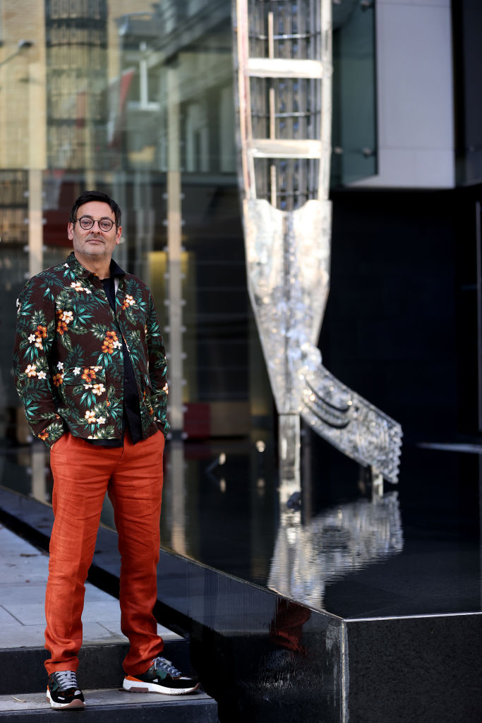 Artist Reuben Paterson poses alongside his 10-metre-high waka in the forecourt of the Auckland Art Gallery Toi o Tāmaki. Photo / Getty Images