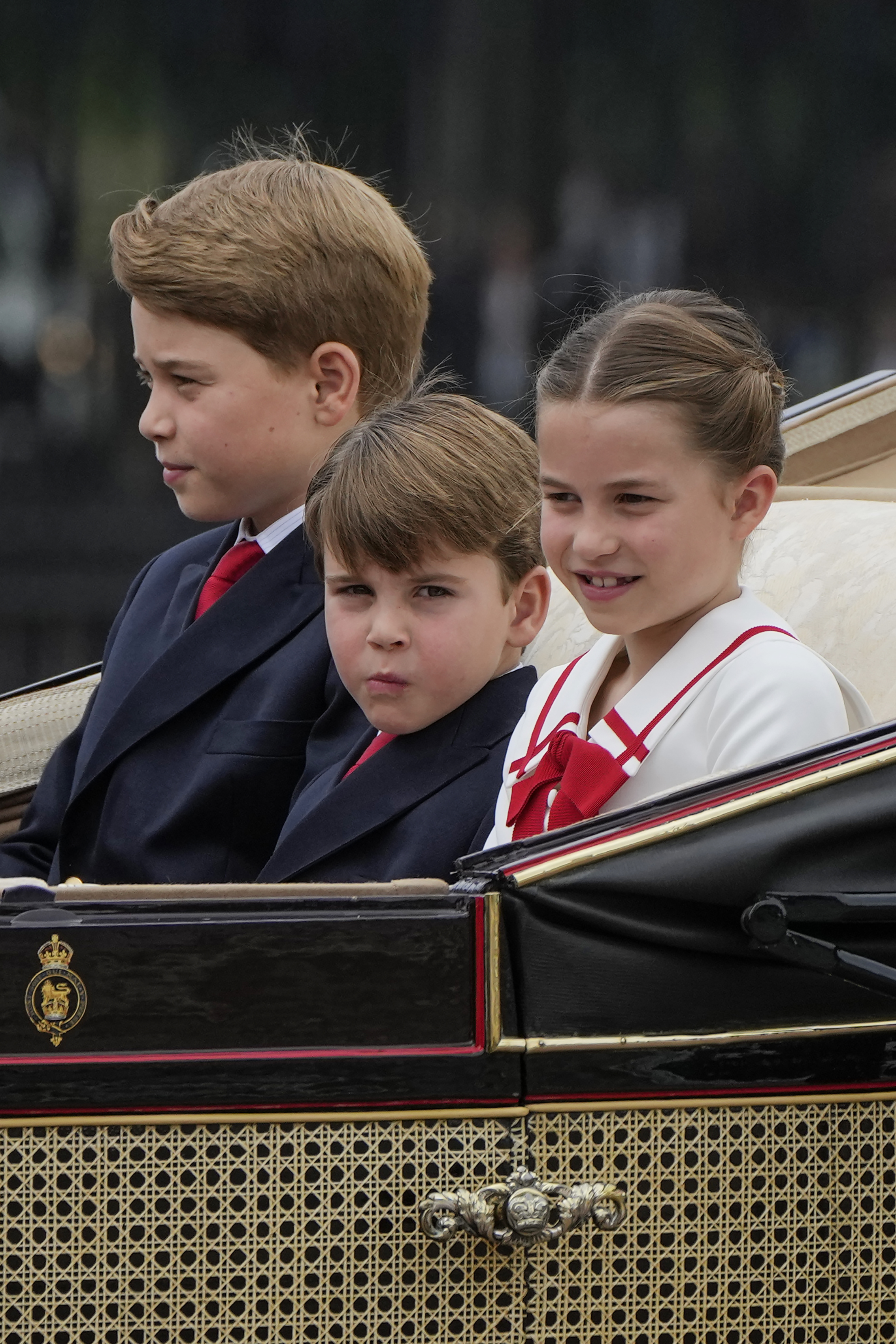 Louis' older siblings kept their composure during the parade. Photo / AP