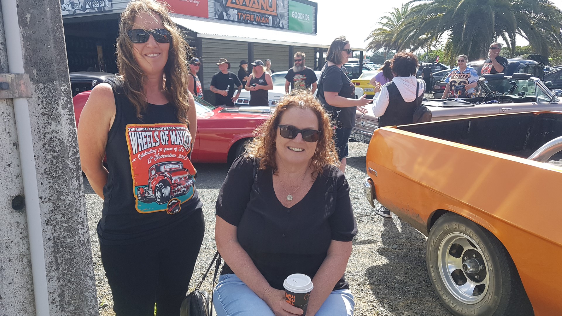 Kylie Payton and Jos Wallace, from the Far North Rod and Custom Club, with some of the flash cars on display on Saturday. The club is gearing up for its Wheels Of Mayhem Show at the Kaitāia A&P Showgrounds on Saturday