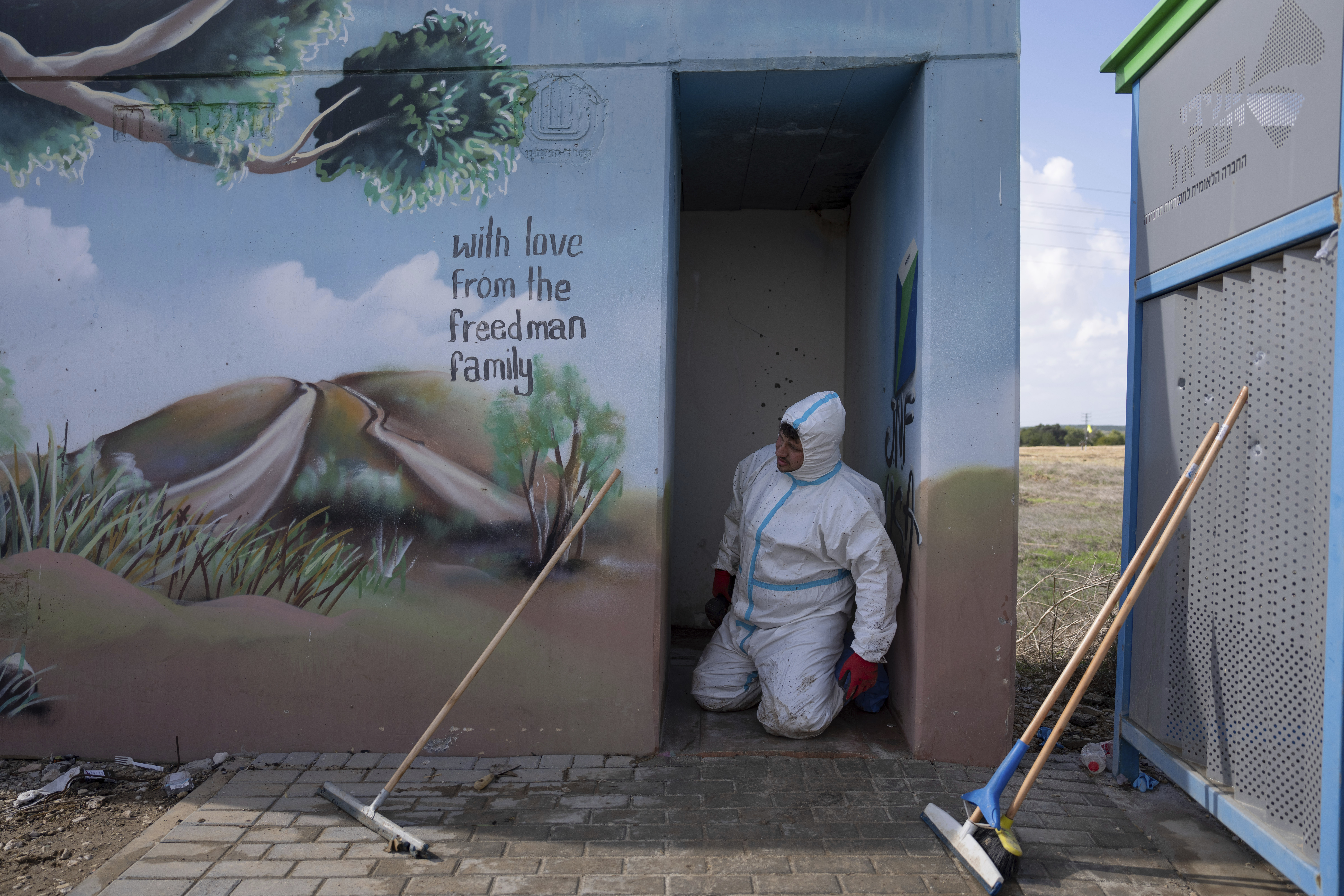 Volunteers from the Zaka rescue service remove blood stains from a public bomb shelter on a road near the Israeli-Gaza border. Photo / AP