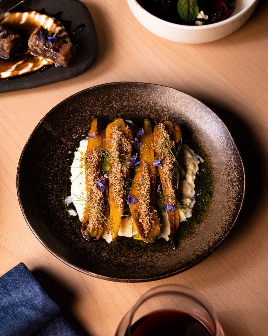 Roasted carrots served on a bed of shaved fennel, stracciatella and hazelnut soil, from restaurant Aurora. Photo / Aurora_adl