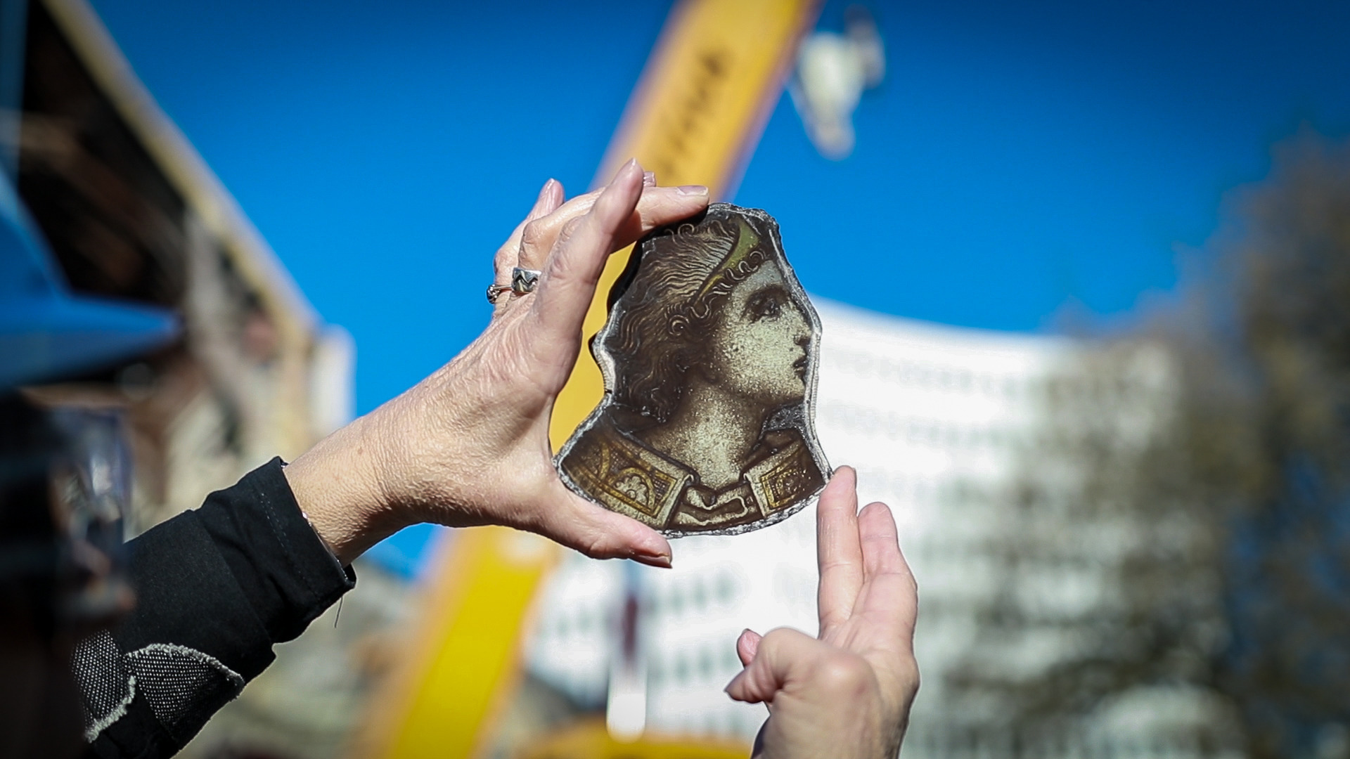 Heritage professional, Jenny May, holds up a piece from the rose window. Photo / Logan Church