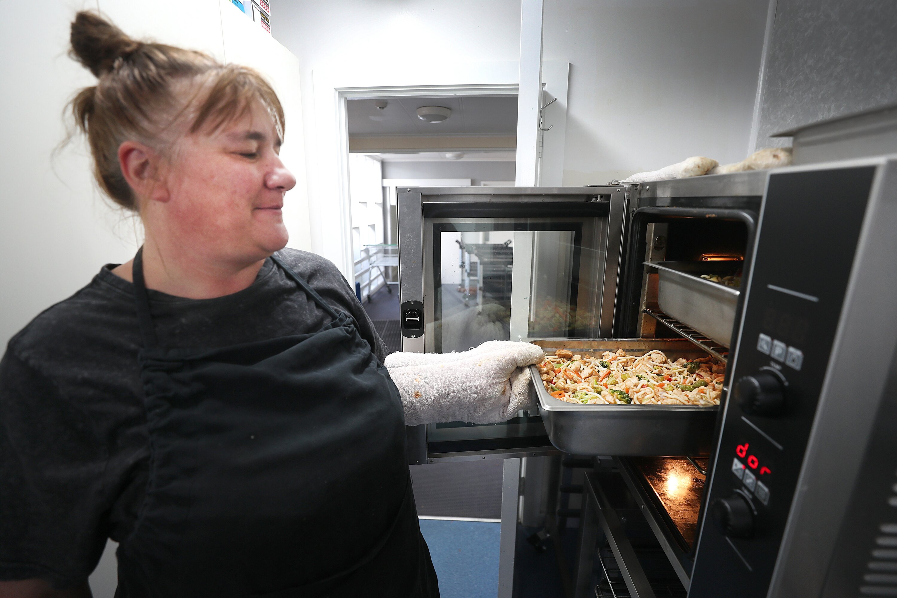Keith Street School cook Maria Firth preparing a meal of chicken stir-fried noodles for students. Photo / Bevan Conley