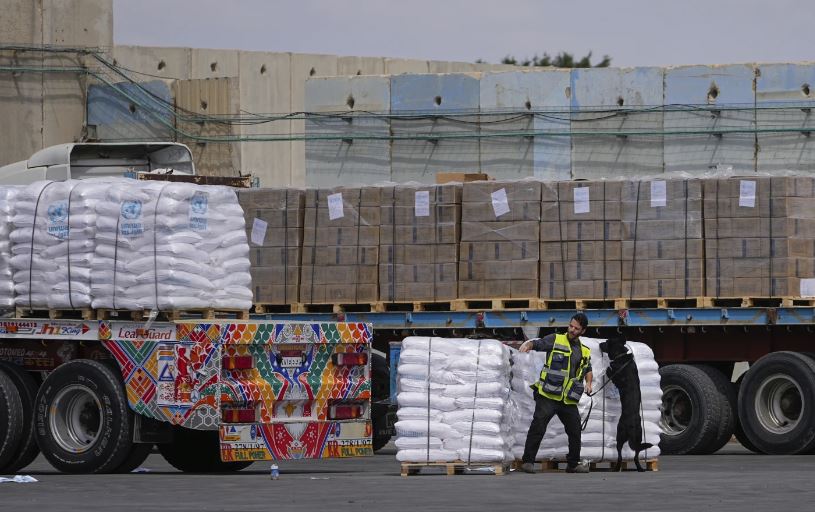 Trucks carrying humanitarian aid for the Gaza Strip pass through the inspection area at the Kerem Shalom Crossing in southern Israel. Photo / AP
