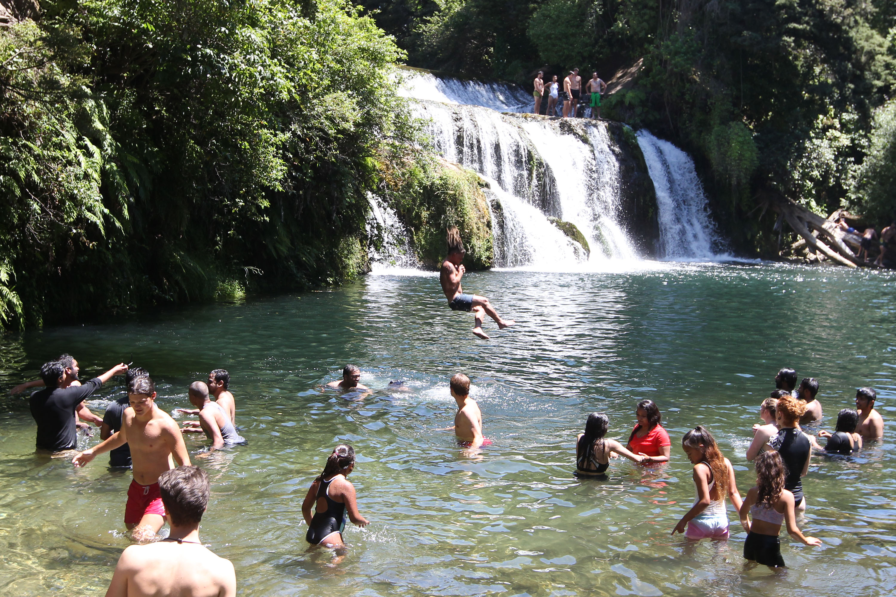People cool off at Maraetotara Falls, near Havelock North, on Christmas Day. Photo / Duncan Brown