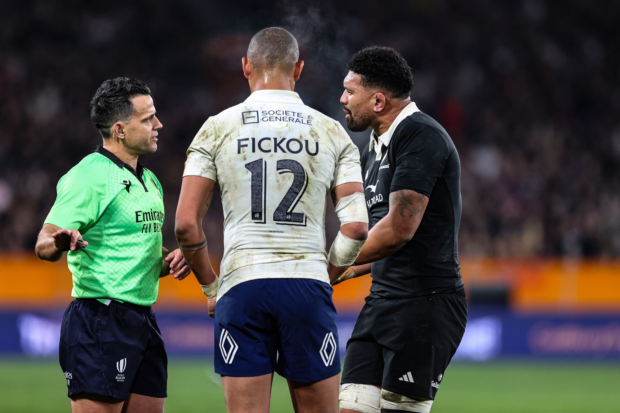 Acting captain Ardie Savea and French captain Gaël Fickou discuss the rules with referee Nic Berry. Photo / Photosport