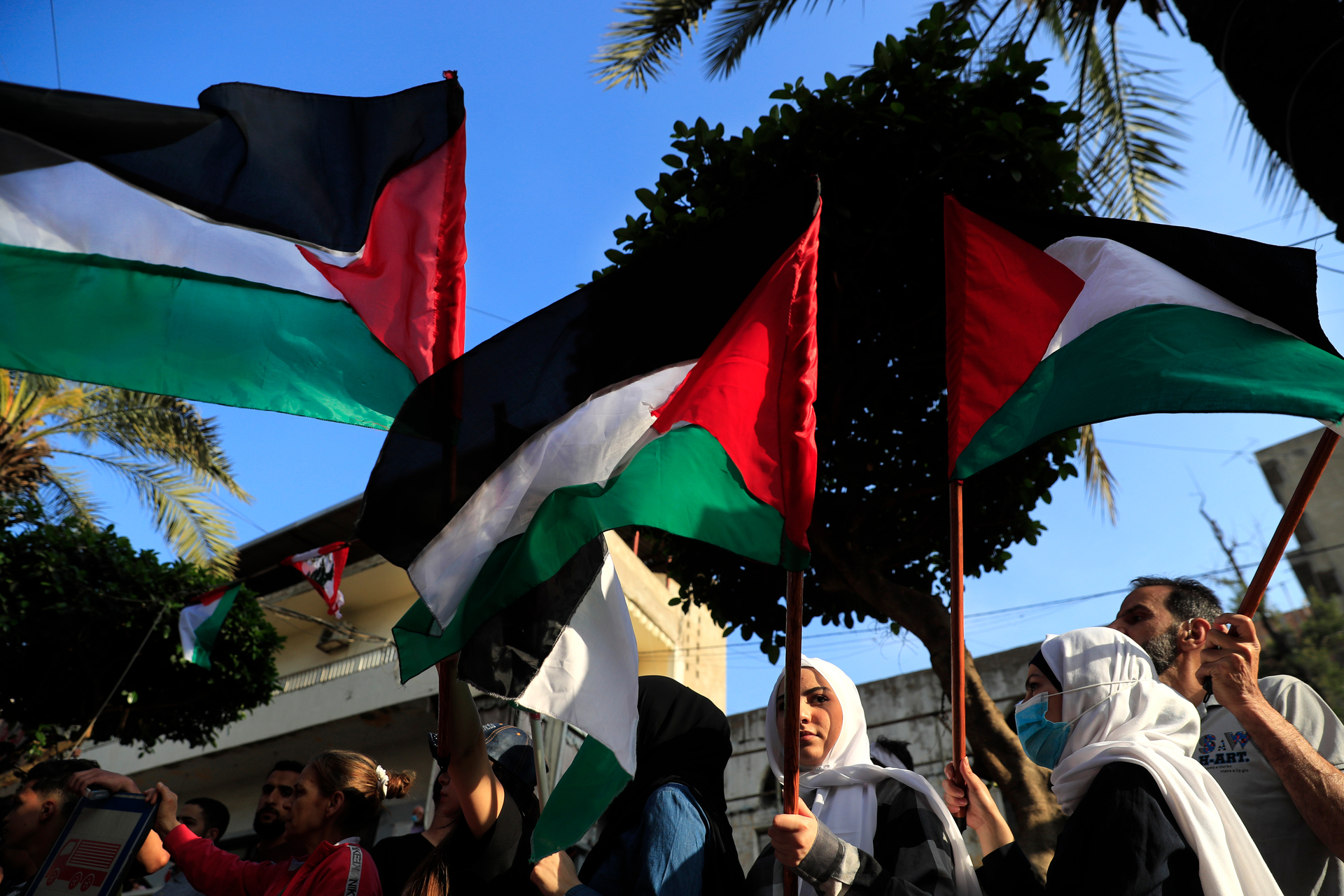 Protesters wave Palestinian flags during a demonstration in Beirut, Lebanon. Photo / AP