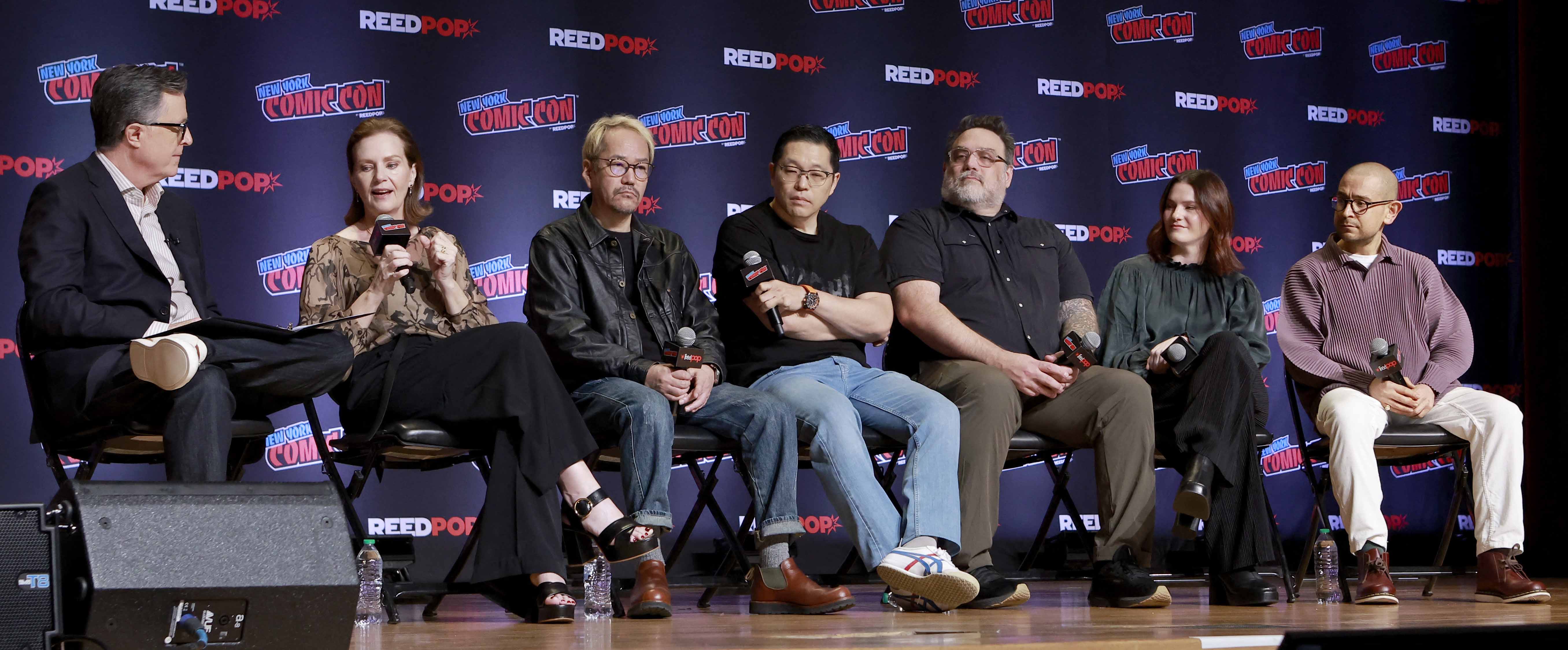 (From left) Stephen Colbert, Philippa Boyens, Kenji Kamiyama, Joseph Chou, Jason DeMarco, Phoebe Gittins and Arty Papageorgiou speak at The Lord of the Rings: The War of the Rohirrim panel at New York Comic Con in October. Photo / AFP