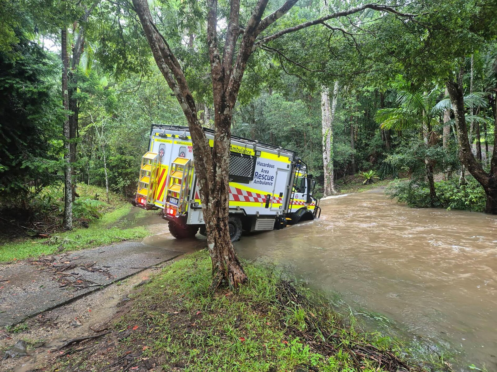 A New South Wales Ambulance Hazardous Area Rescue Ambulance (HARA) navigates floodwaters.