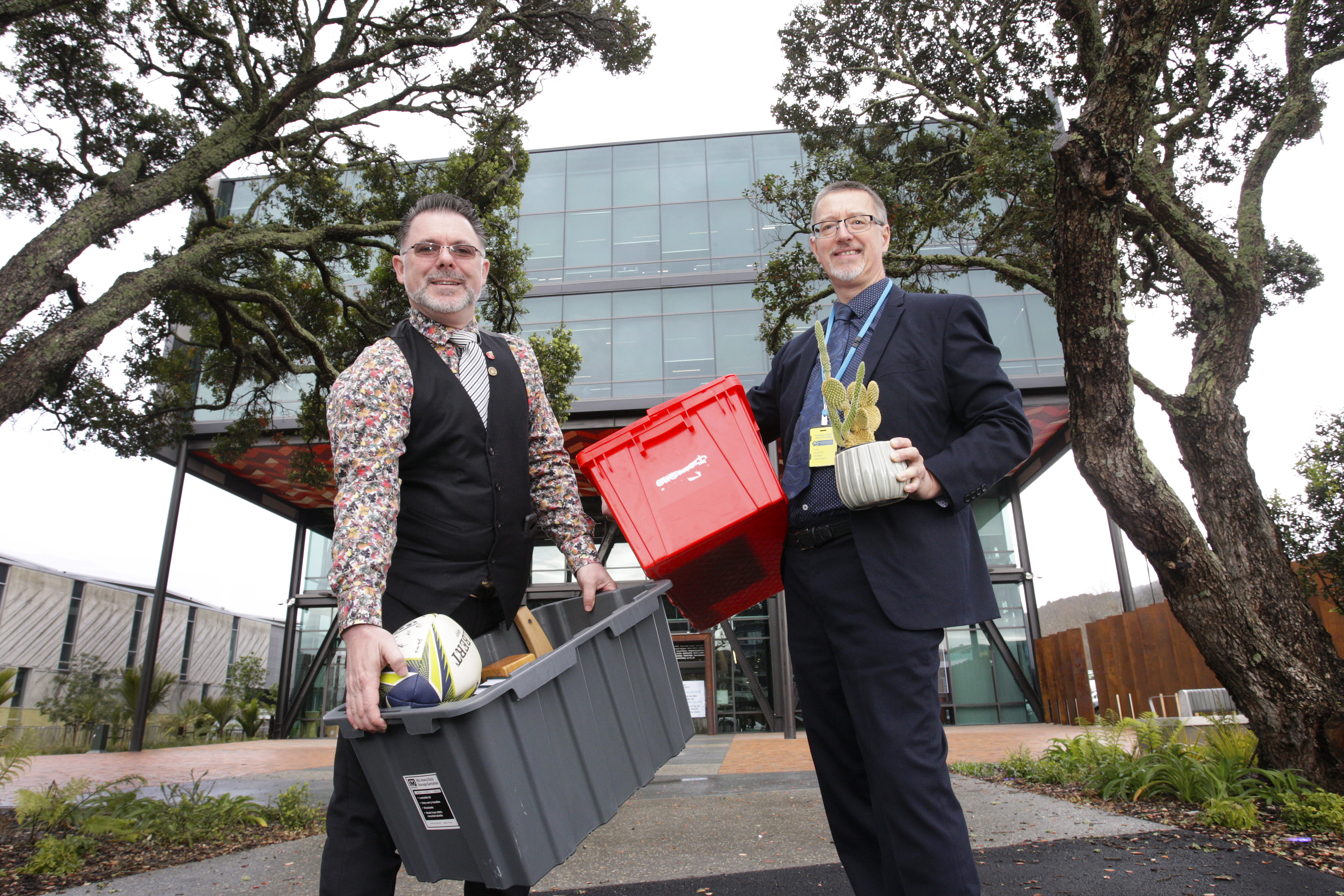 Whangārei Mayor Vince Cocurullo (left) and council chief executive Simon Weston shift some of their office items to the new Civic Centre from Forum North on Friday. Cocurullo's accoutrements include a Women's Rugby World Cup ball signed in 2022 by the Italian women's team and for Weston, a cactus - without a name. Photo / Tania Whyte