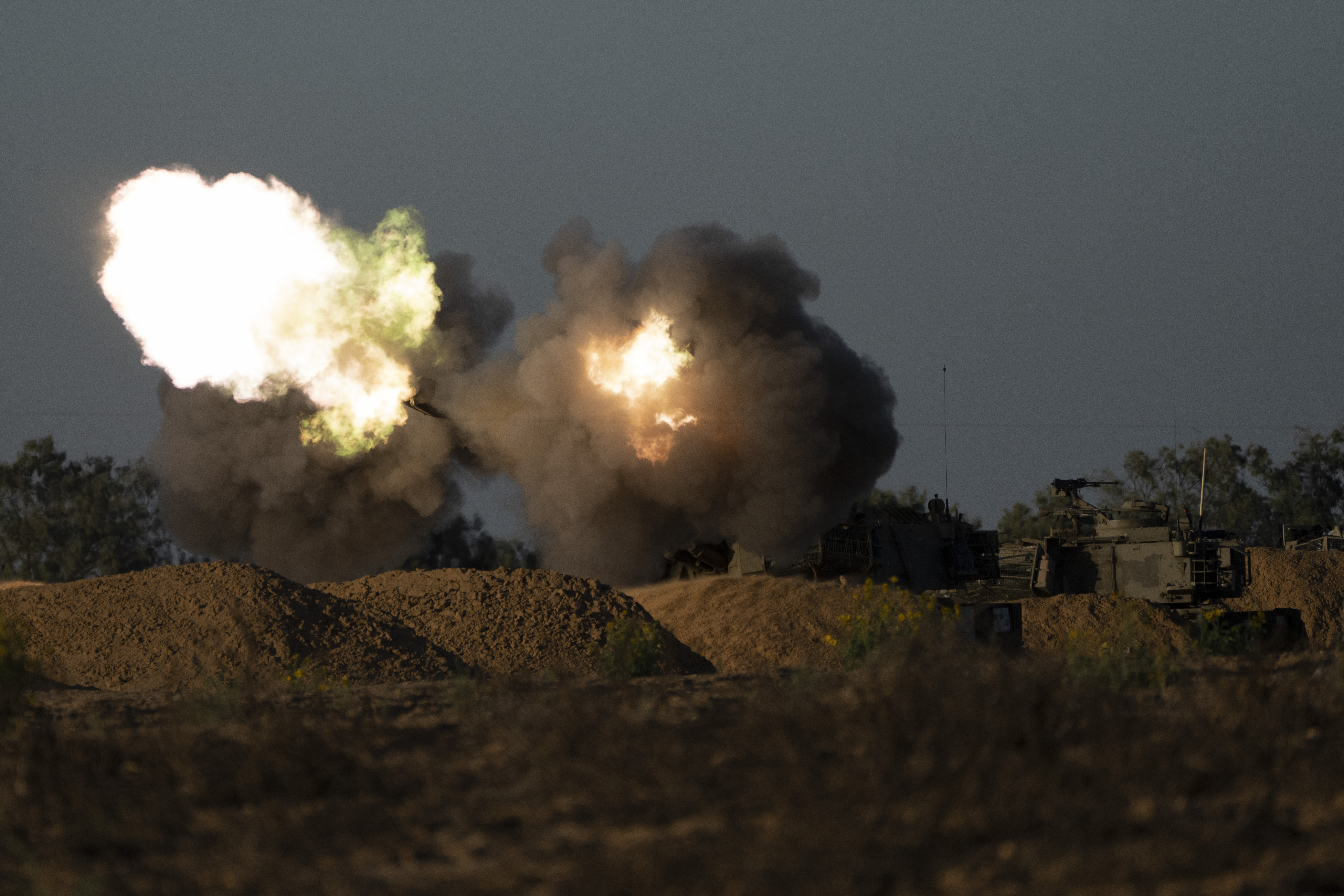 An Israeli mobile artillery unit fires a shell from southern Israel towards the Gaza Strip, in a position near the Israel-Gaza border. Photo / AP 