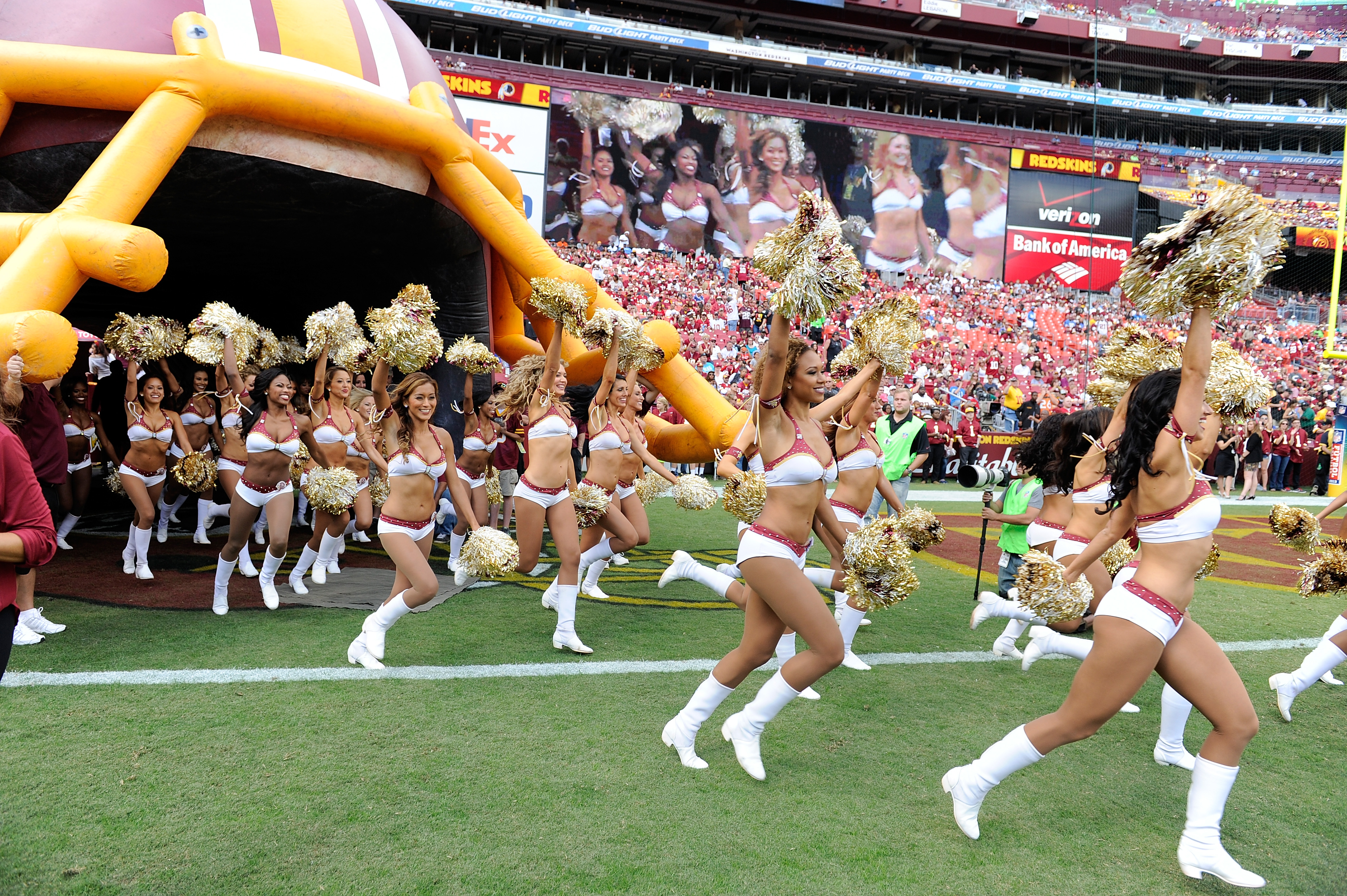 A Washington Redskins cheerleader performs in a Santa Claus costume,  holding a gift during a break in the NFL action between the Redskins and  the Dallas Cowboys, at FedEx Field, Landover Maryland