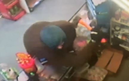 The moment an armed man reached over the counter of the Cornwall Park Store to swing an axe at Singh, caught on CCTV. Photo / Cornwall Park Store