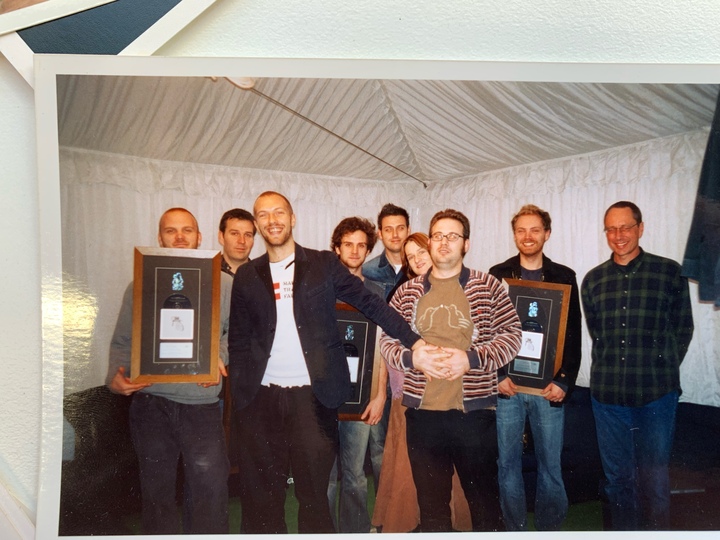 Chris Martin of Coldplay photographed with Morgan Donoghue (wearing a striped jumper) at a platinum disc presentation for the A Rush of Blood to the Head album, in Auckland in July 2003. 