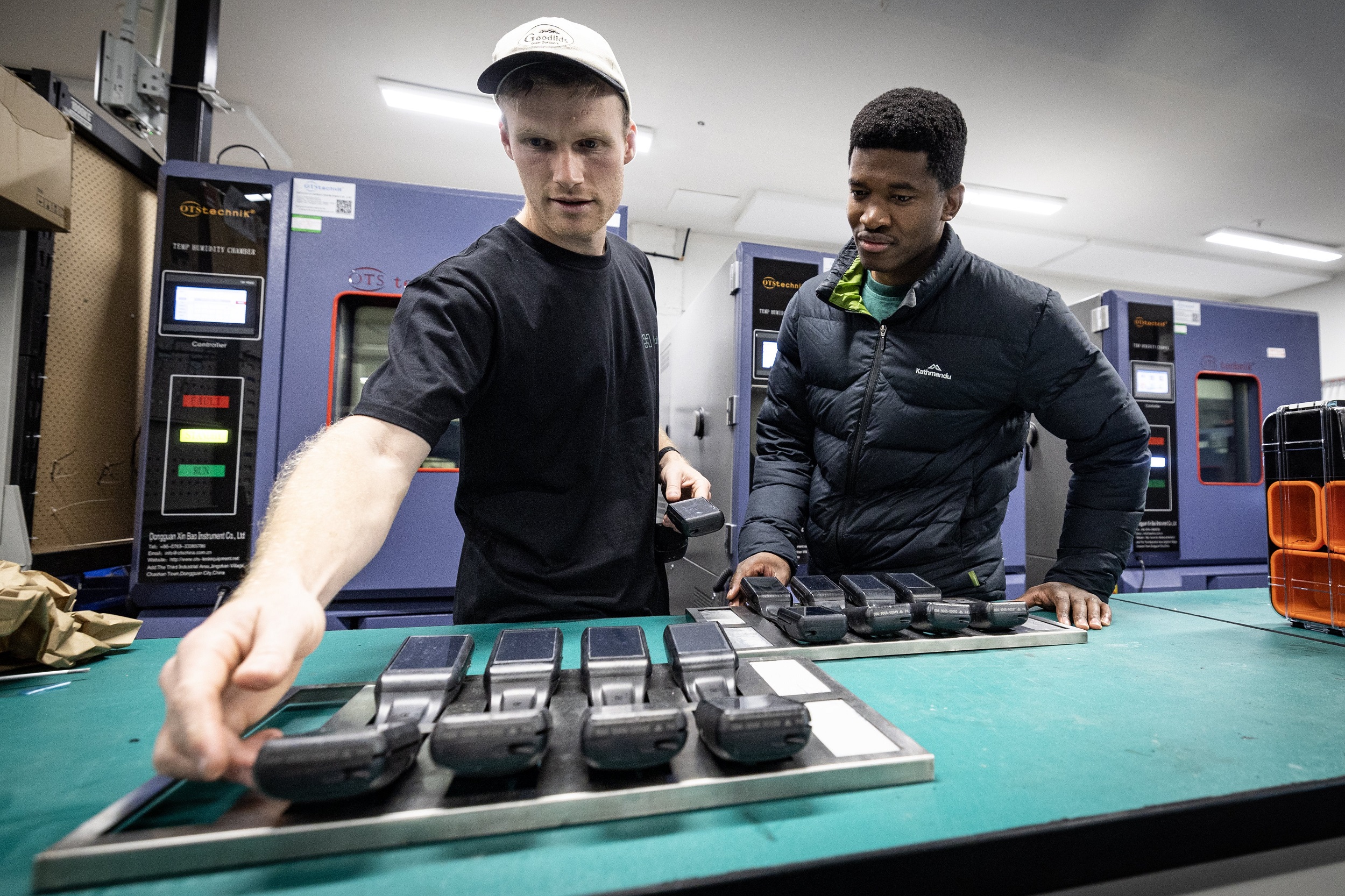 Piggott (left) with Halter beef cattle specialist Phathisa Khumalo in the firm's R&D lab. The chambers at the rear are used to bake the collars as part of a process to simulate long-term wear and tear. The product is also dunked in a high-pressure water tank as part of the same assessment process. Photo / Jason Oxenham