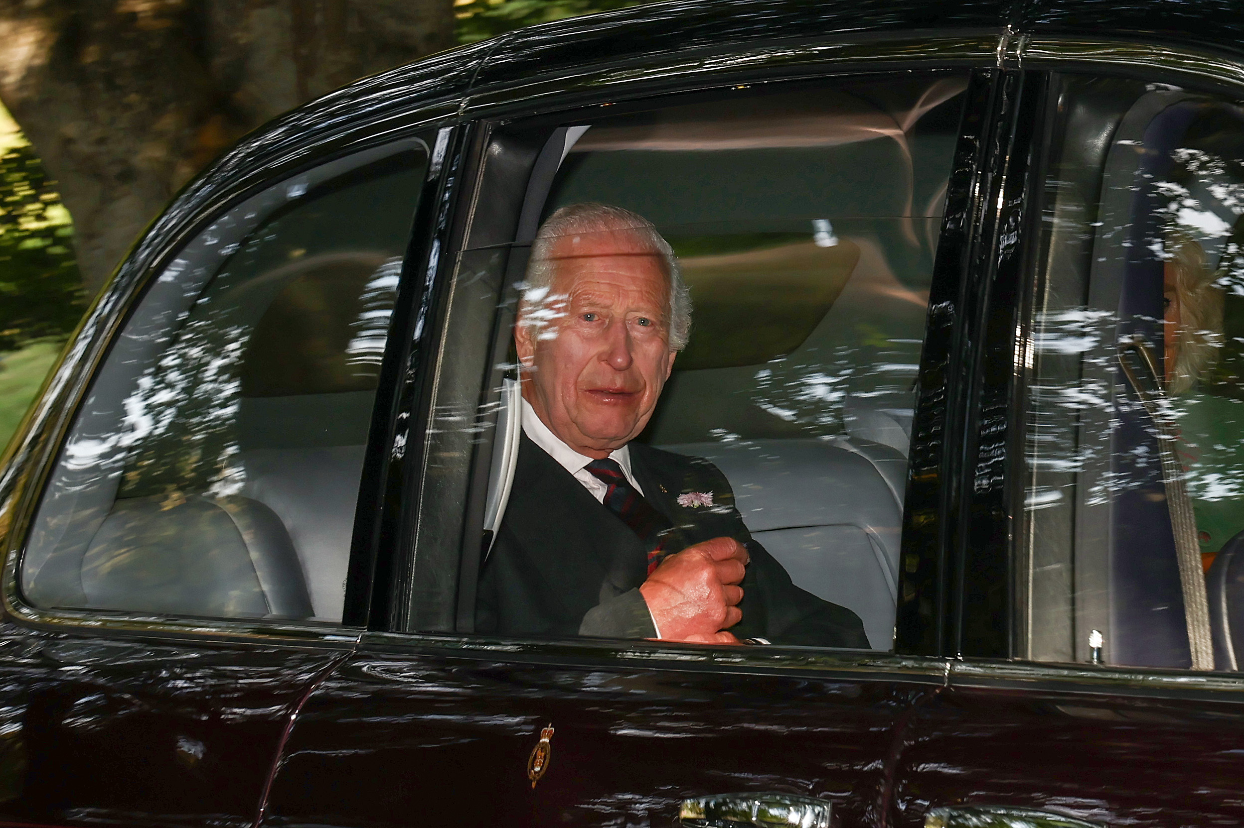King Charles III and Queen Camilla arrive by car at Crathie Kirk to attend the church service. Photo / Getty Images