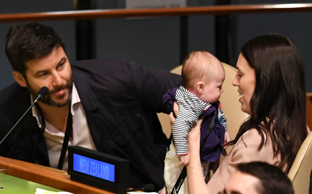 Jacinda Ardern holds her daughter Neve at the United Nations General Assembly, flanked by her partner Clarke Gayford. Photo / AFP