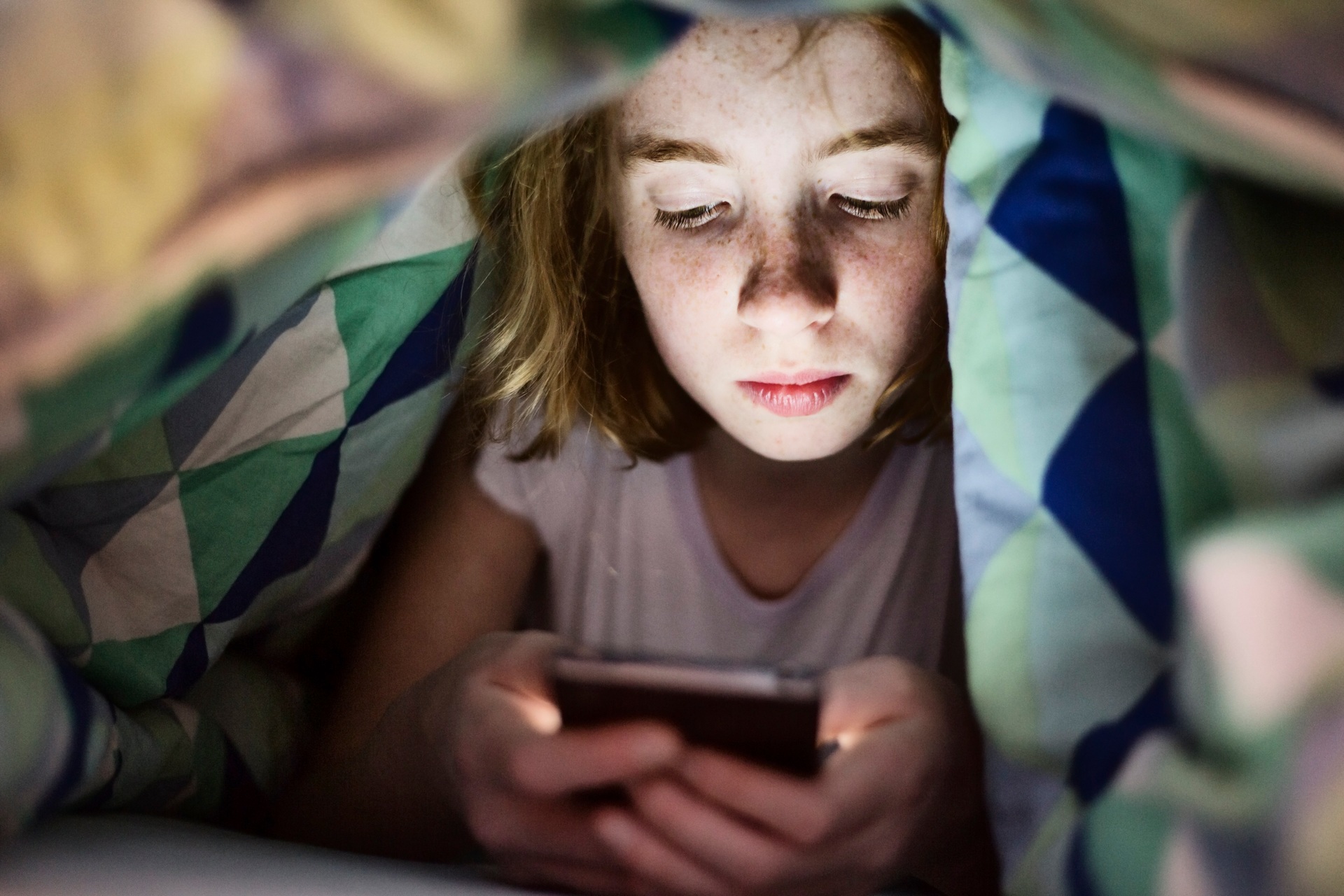 Research suggests that in addition to altering our sleep patterns, the blue light from our phone screens could be accelerating blindness. Photo / Getty Images