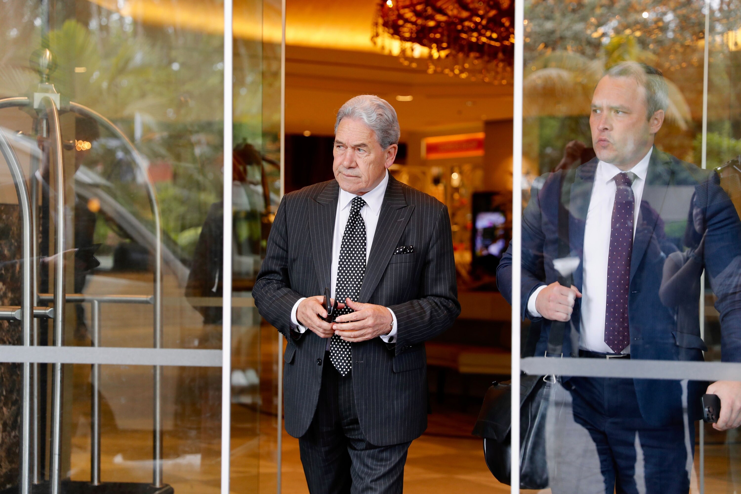 New Zealand First Party leader Winston Peters and chief of staff Darroch Ball leave the Cordis Hotel yesterday after talks with National's Christopher Luxon. Photo / Dean Purcell
