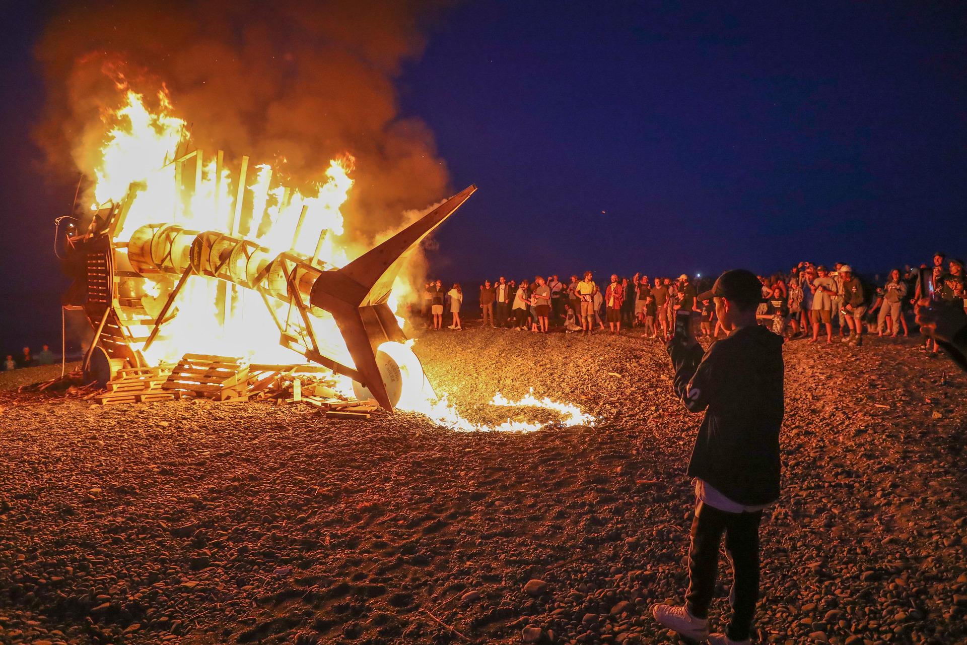 Thousands turned out to see the fish sculpture burn on the beach. Photo / Warren Buckland