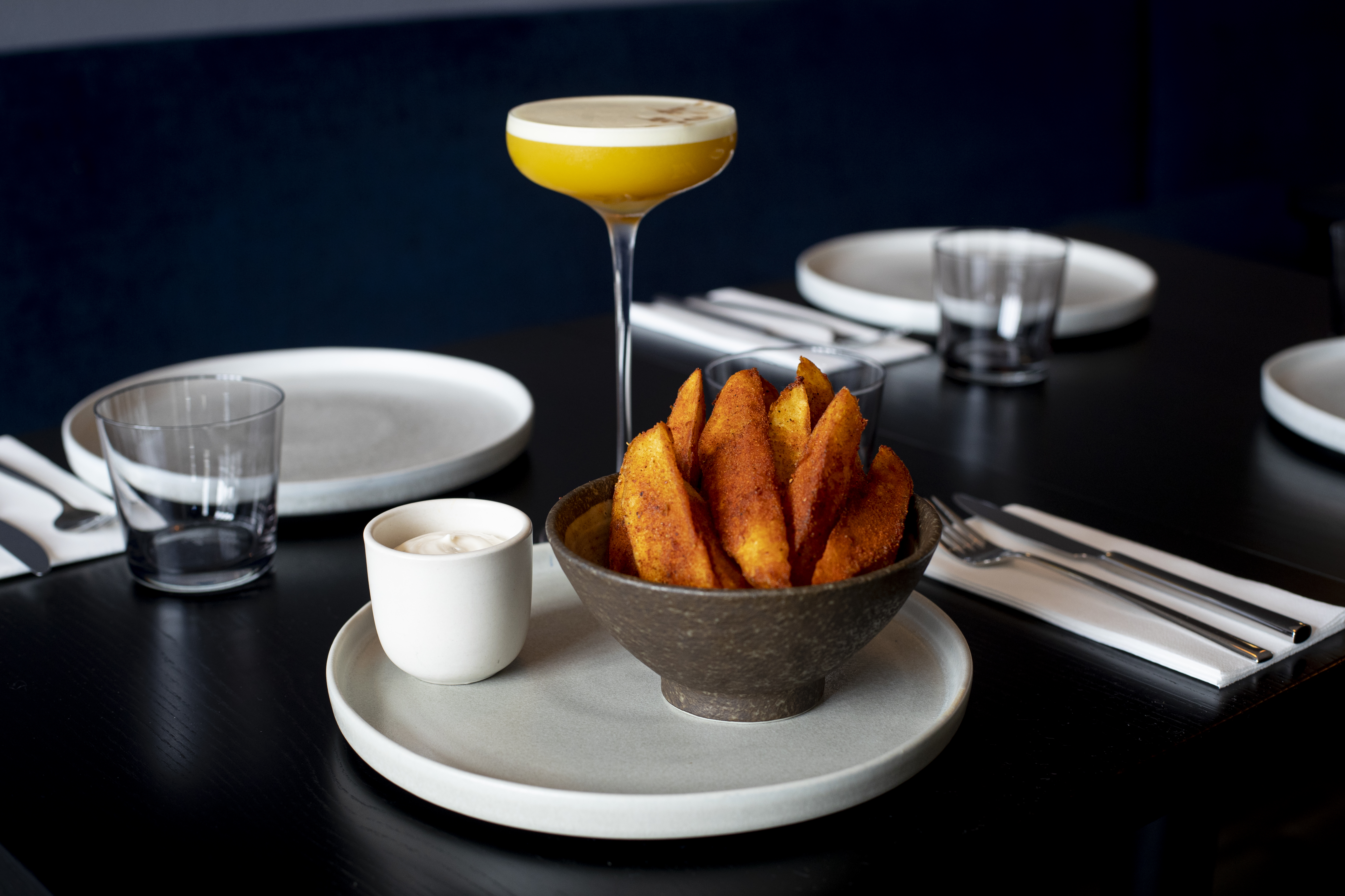 Vindaloo fries and a cocktail from KOL. Photo / Dean Purcell