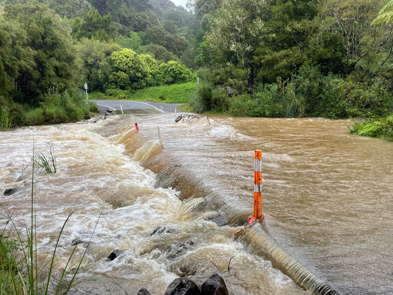 Floodwaters swamp a road in Kauaeranga Valley, Coromandel. Photo / Ninette Birck