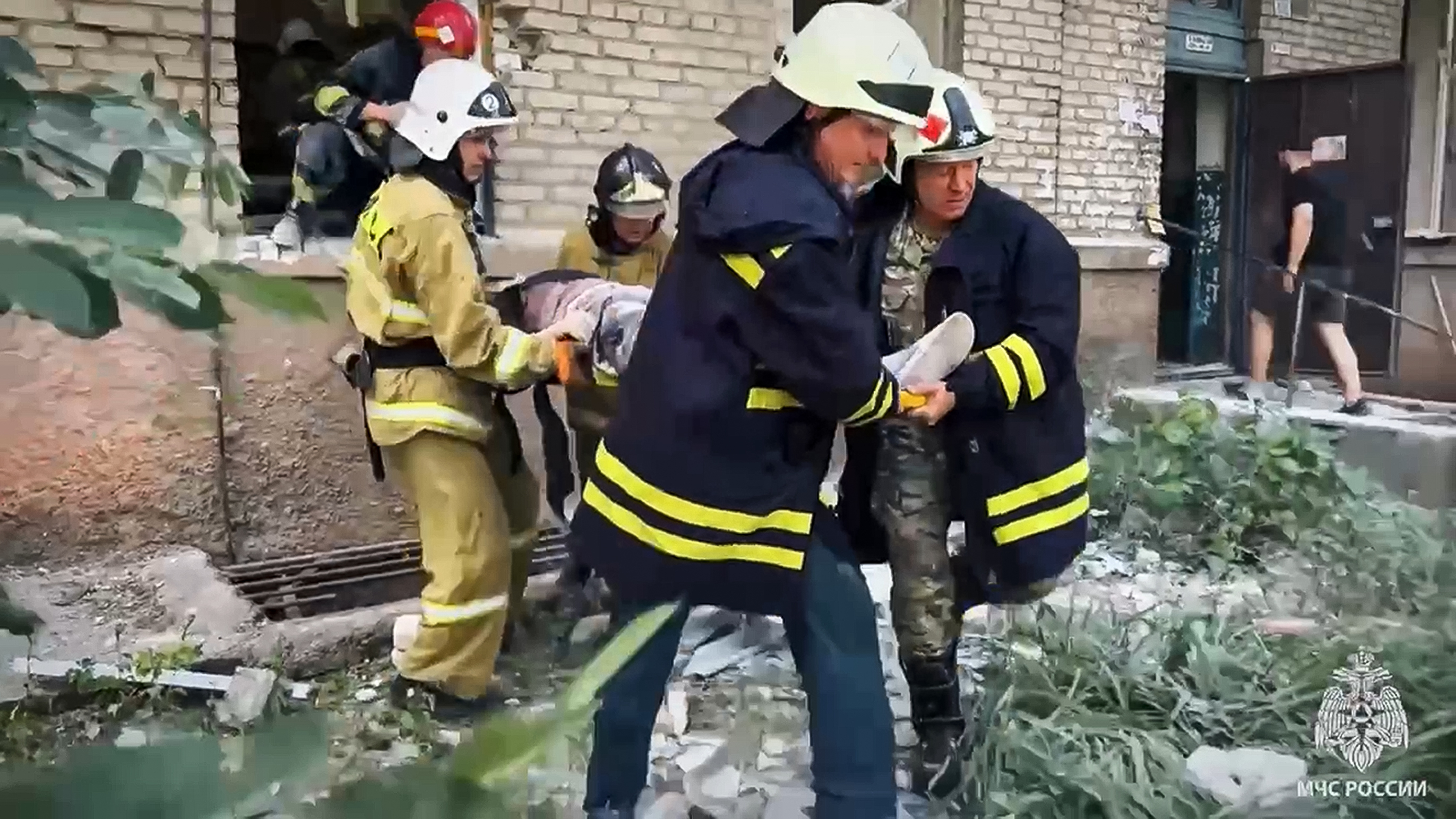 Emergency Ministry employees carry a wounded person from the side of the damaged apartment building following Friday's Ukrainian missile attack on Luhansk, the capital of Russian-controlled Luhansk region, eastern Ukraine. Photo / AP