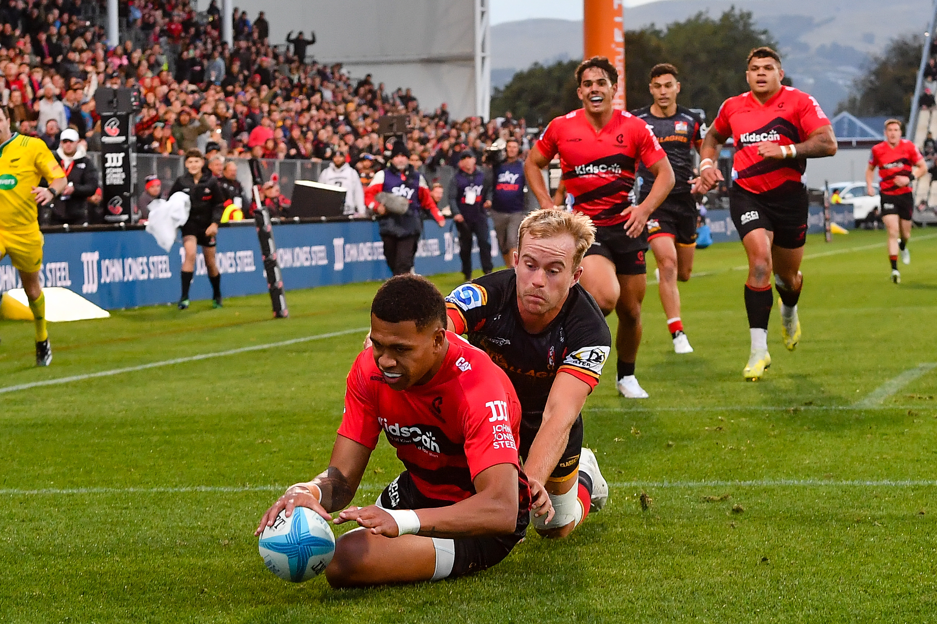 Chay Fihaki of the Crusaders scores a try against the Chiefs. Photo / Photosport