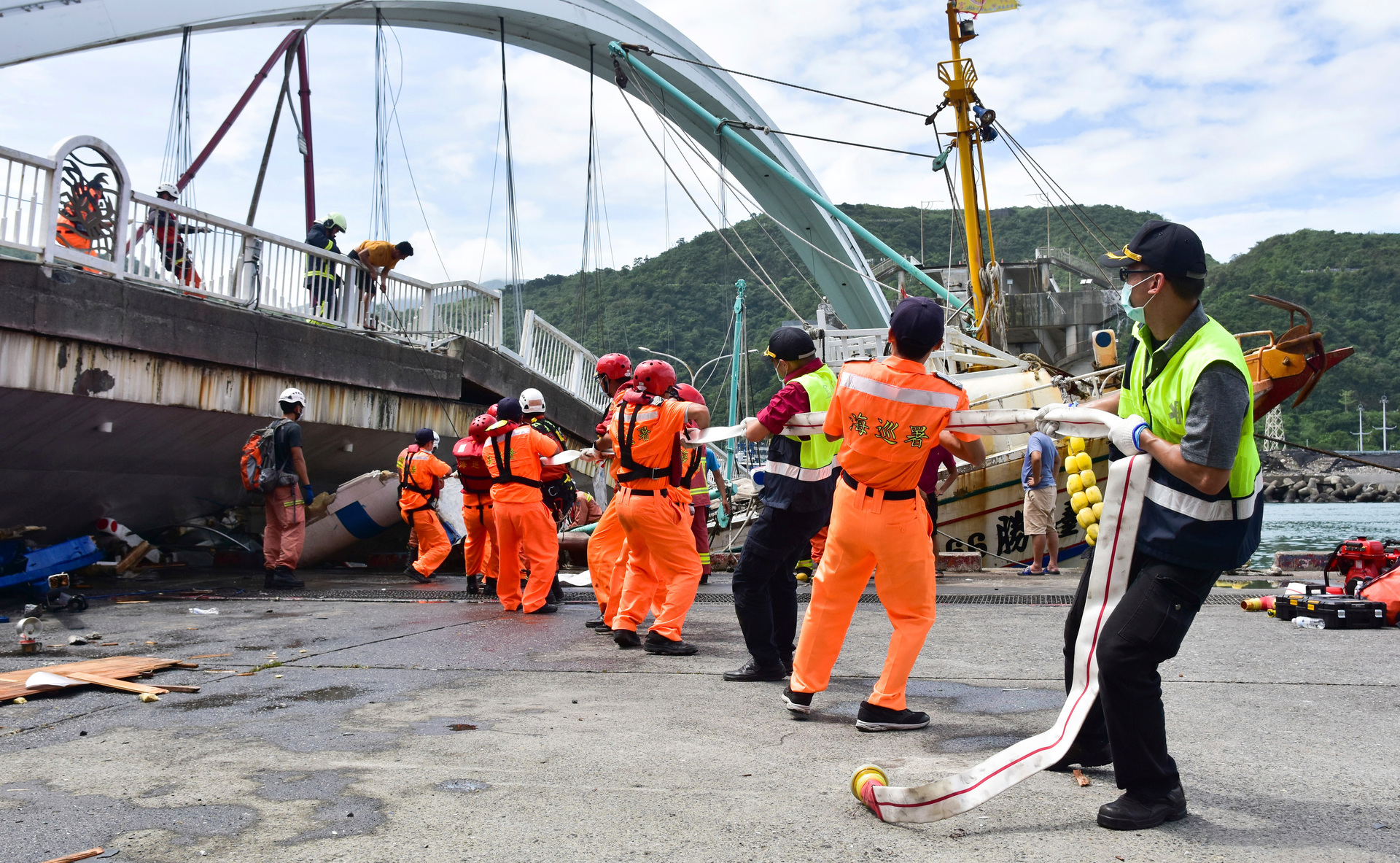 Rescuers work near the site of a collapsed bridge in Nanfangao. Photo / AP