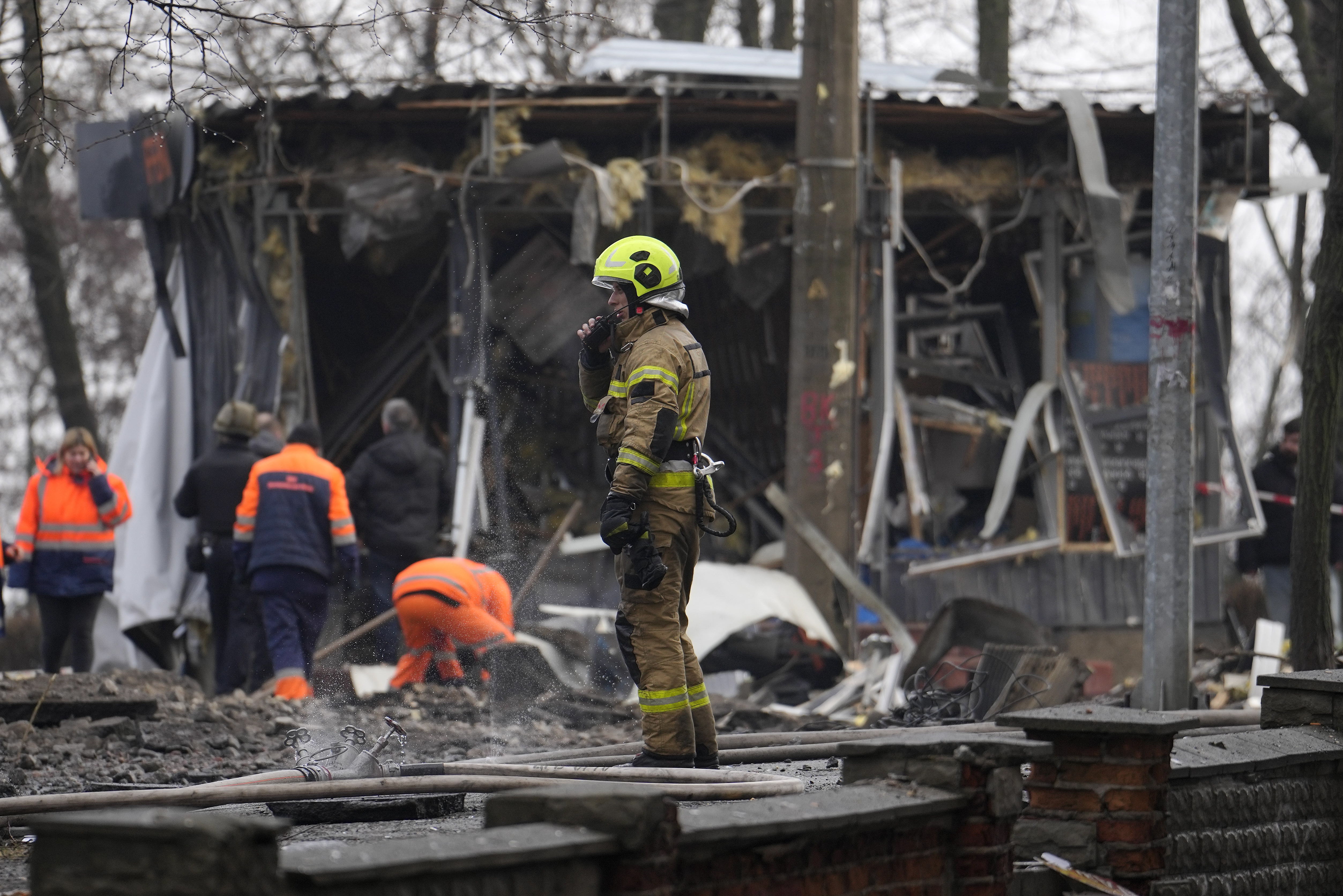 A firefighter stands amongst the debris after a Russian attack in Kyiv, Ukraine. Photo / AP