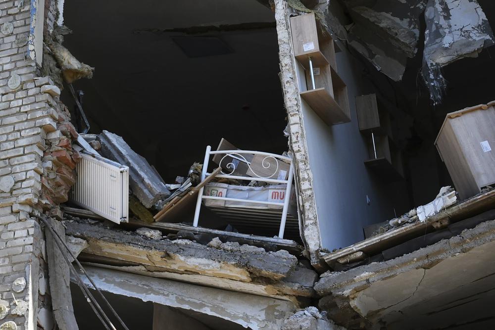 A child's bed is seen inside an apartment building damaged by Russian shelling in Bakhmut. Photo / AP