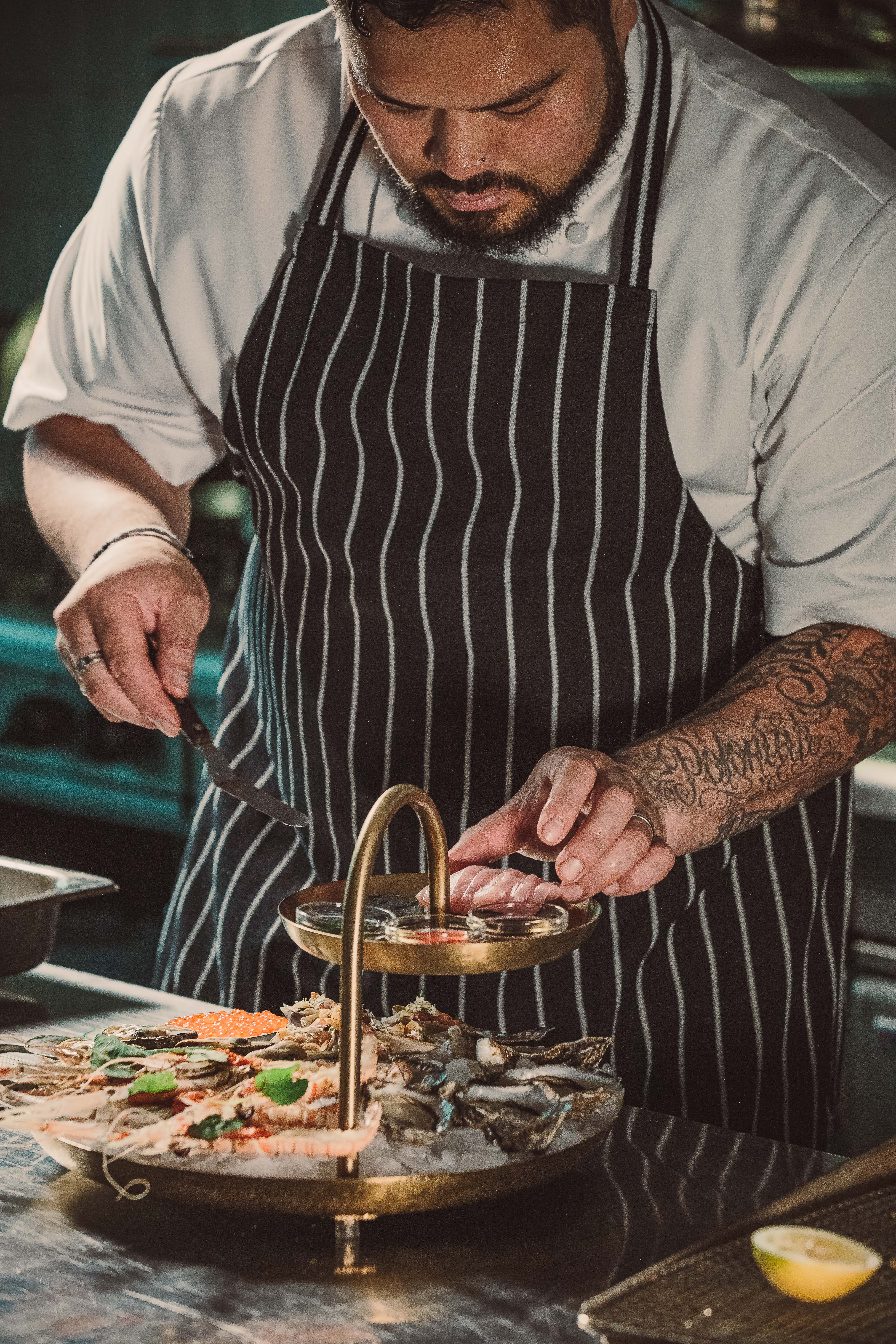 The Grill’s new exec chef Touvai Poloniati perfects the seafood tower.