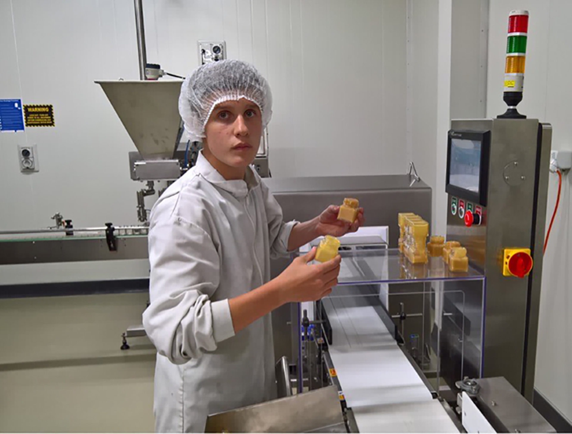 Levi Courage working in the honey factory at Gloriavale. Photo / Supplied